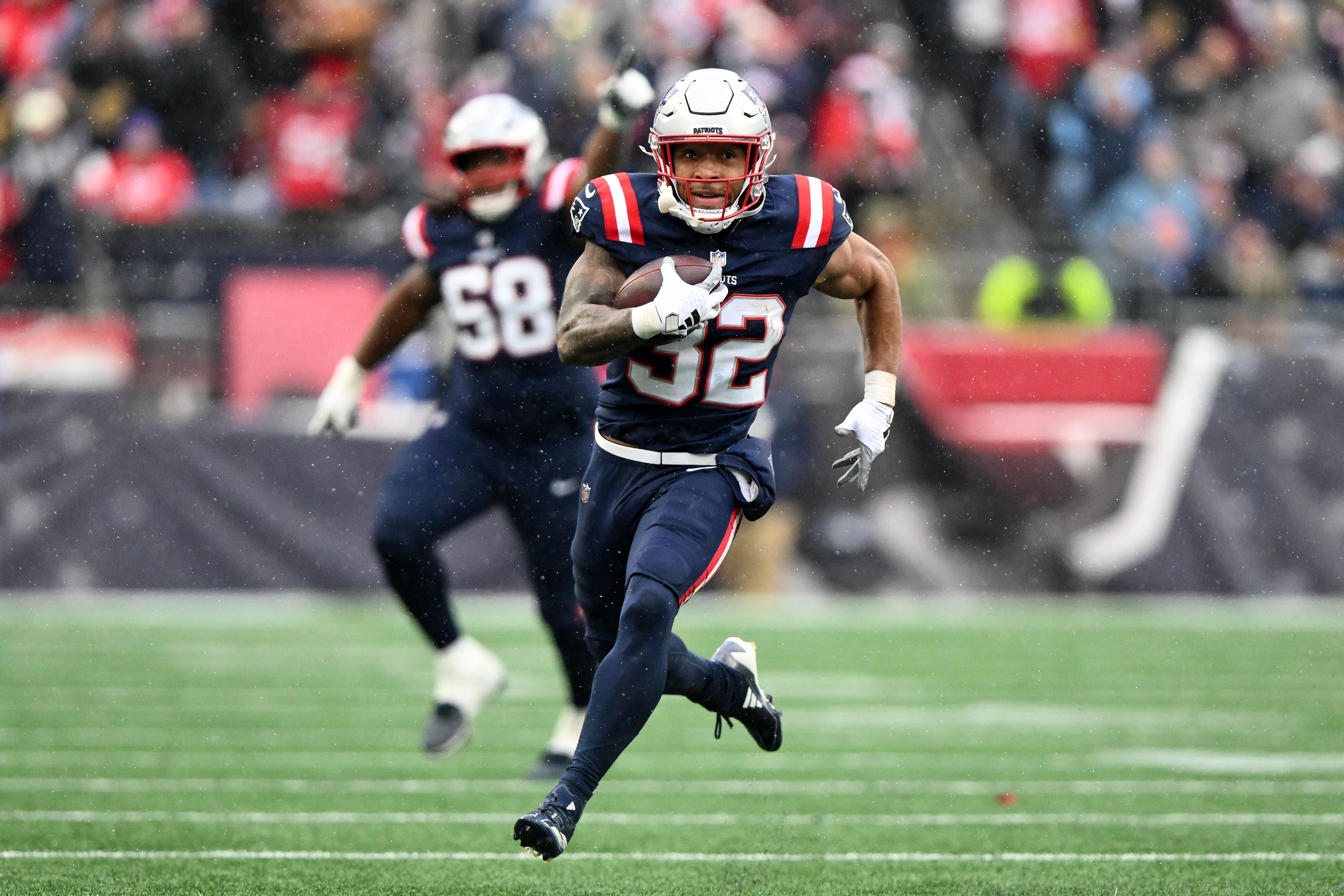 New England Patriots running back Treveyon Henderson (32) runs for a touchdown as we break down our Patriots vs. Ravens expert picks for Sunday Night Football.