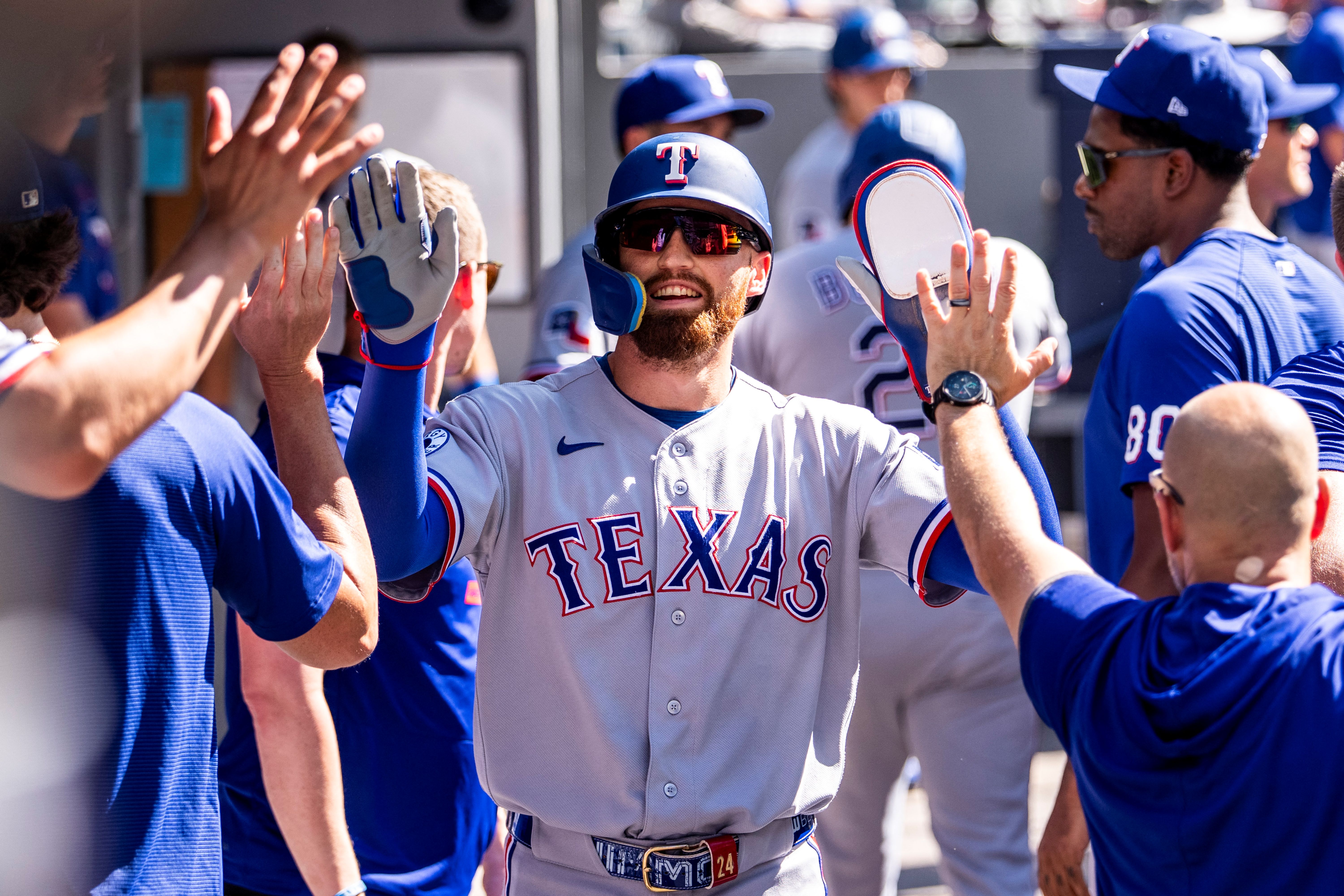 Texas Rangers right fielder Brandon Nimmo celebrates with teammates, and he's featured in my Rangers vs. Angels prediction.