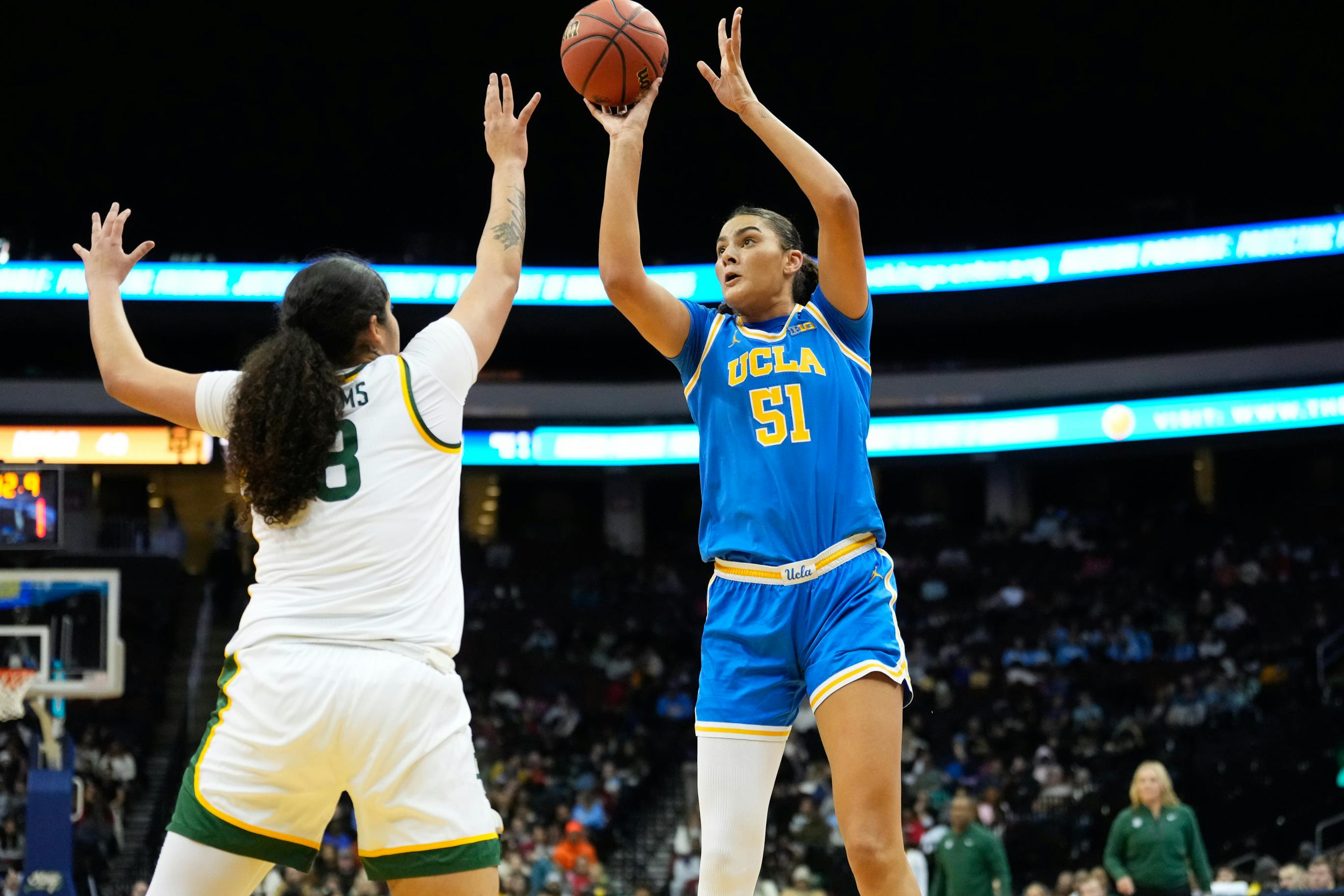 UCLA center Lauren Betts scores a basket against Baylor forward Kayla Nelms. The Bruins beat Women