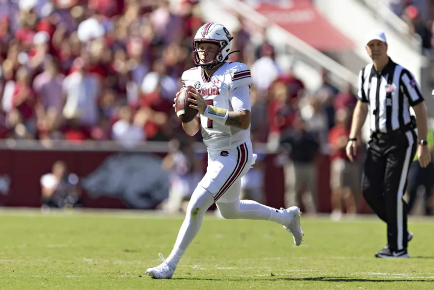 Spencer Rattler of the South Carolina Gamecocks rolls out looking for a receiver against the Arkansas Razorbacks.