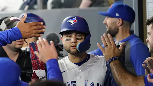 Toronto Blue Jays shortstop Bo Bichette gets congratulated, and he's key to our Dodgers vs. Blue Jays same-game parlay