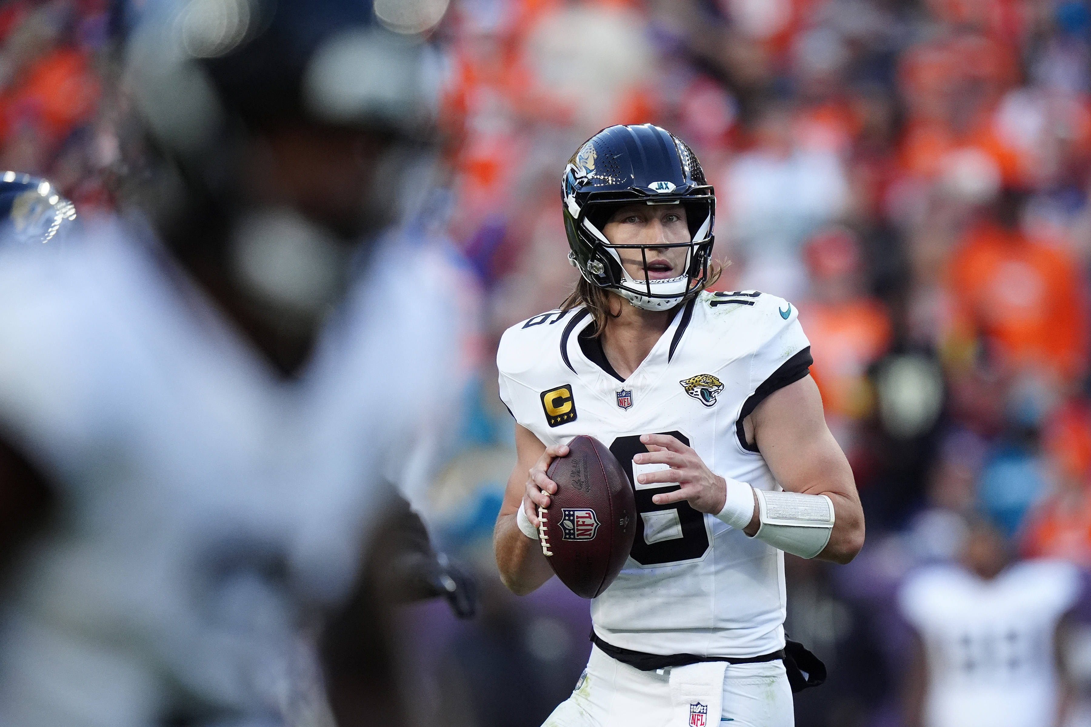 Jacksonville Jaguars quarterback Trevor Lawrence (16) drops back to pass as we break down our NFL AI predictions for Week 17.