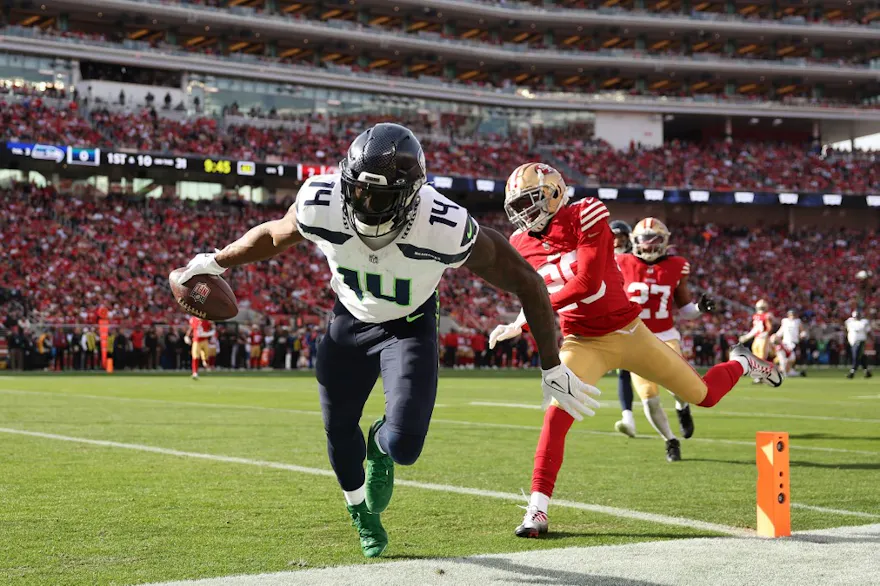 DK Metcalf #14 of the Seattle Seahawks scores a touchdown as we round up our NFL predictions for Week 15