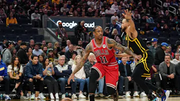 DeMar DeRozan #11 of the Chicago Bulls dribbles the ball against Stephen Curry #30 of the Golden State Warriors as we look at the closing 2024 NBA Clutch Player of the Year odds.