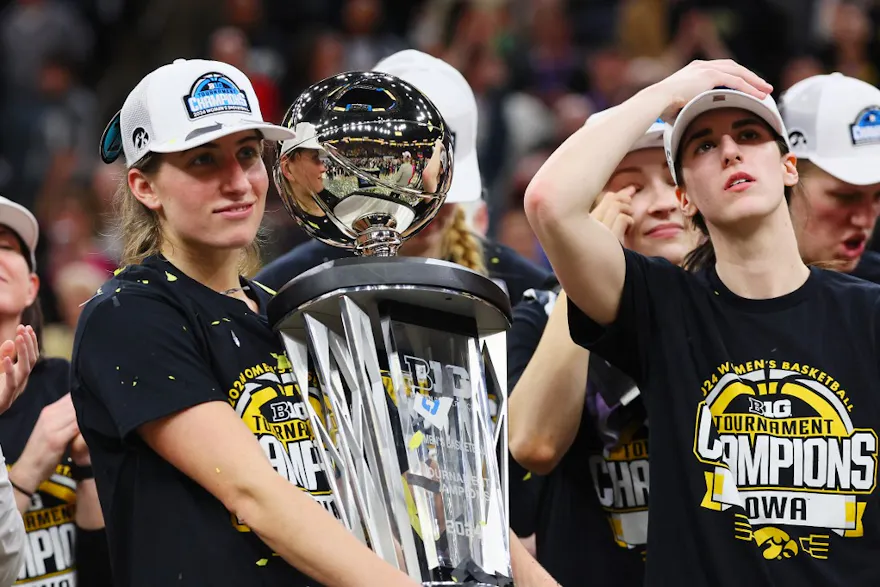 Kate Martin #20 of the Iowa Hawkeyes holds the trophy as we look at our Holy Cross vs. Iowa expert pick