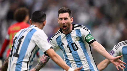 Argentina's forward #10 Lionel Messi celebrates scoring the opening goal with his teammate Argentina's midfielder #11 Angel Di Maria during the Qatar 2022 World Cup Group C football match between Argentina and Mexico at the Lusail Stadium in Lusail, north