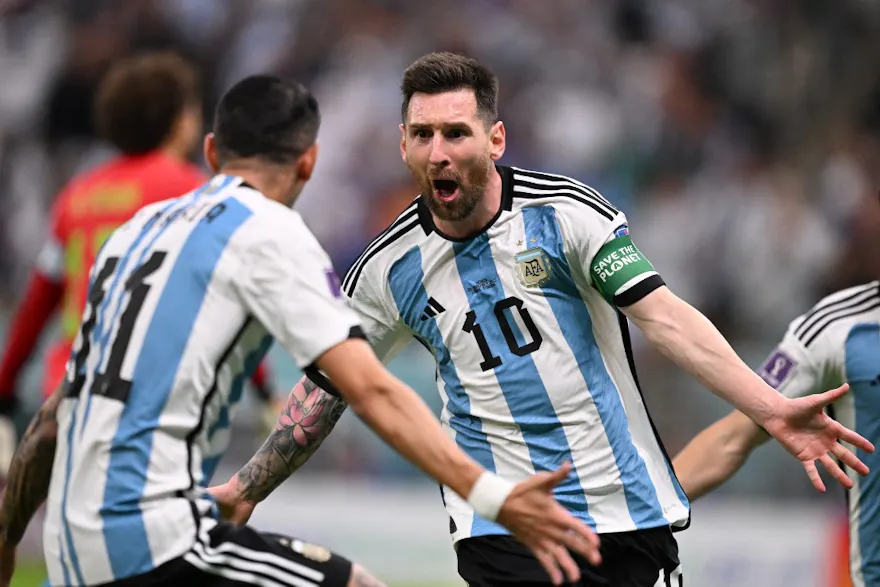Argentina's forward Lionel Messi celebrates scoring the opening goal with his teammate Argentina's midfielder Angel Di Maria during the Qatar 2022 World Cup Group C football match at the Lusail Stadium in Lusail, north of Doha. Kirill Kudryavtsev / AFP.