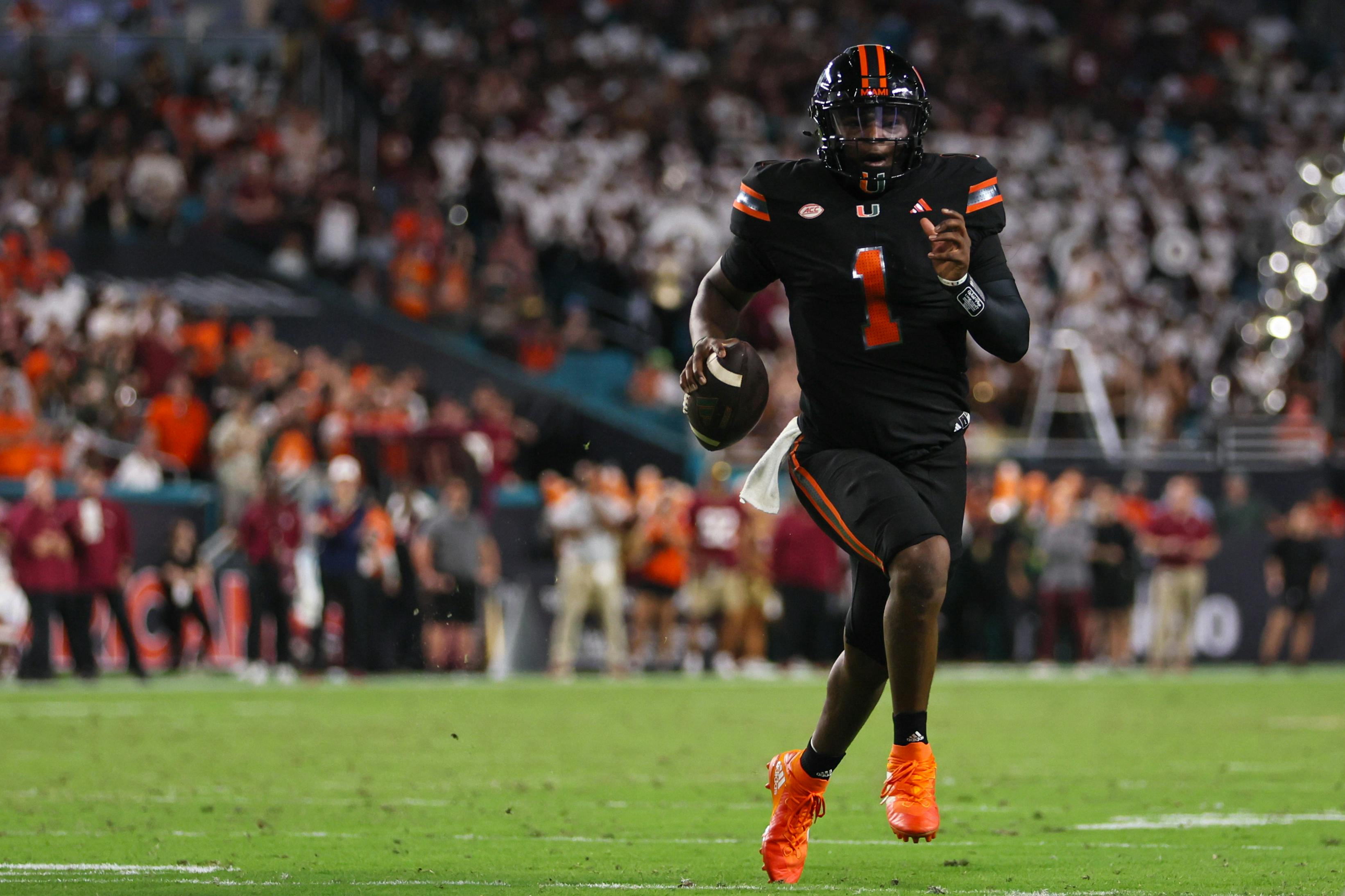 Miami quarterback Cam Ward runs with the football against Florida State. Ward is among the favorites by the 2025 NFL Draft odds.