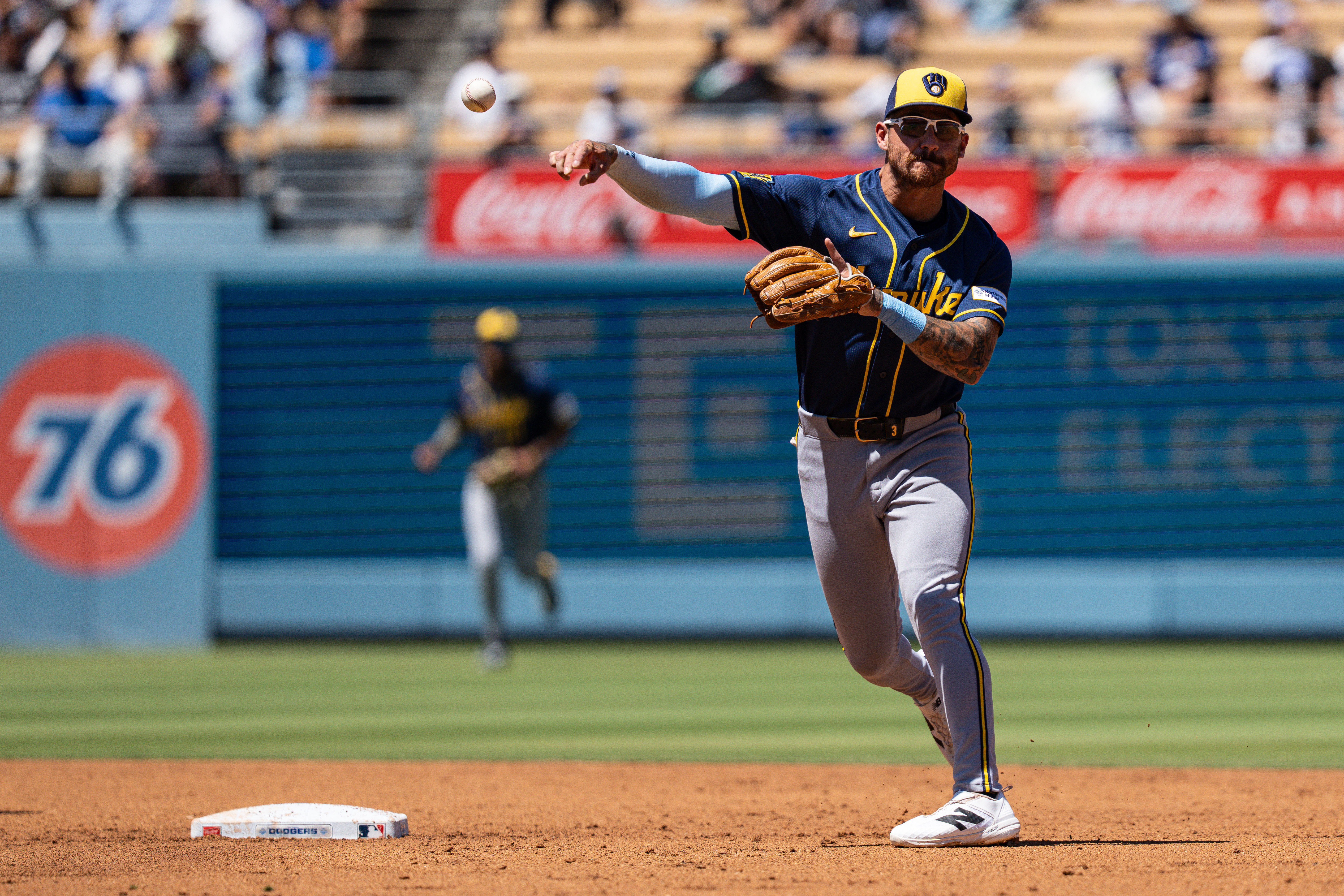 Milwaukee Brewers shortstop Joey Ortiz turns a double play as we make our best Braves vs. Brewers prediction