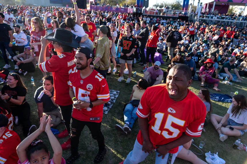 Kansas City Chiefs fans cheer at an NFL watch party during the Super Bowl, as we look at the five biggest Super Bowl party fouls.