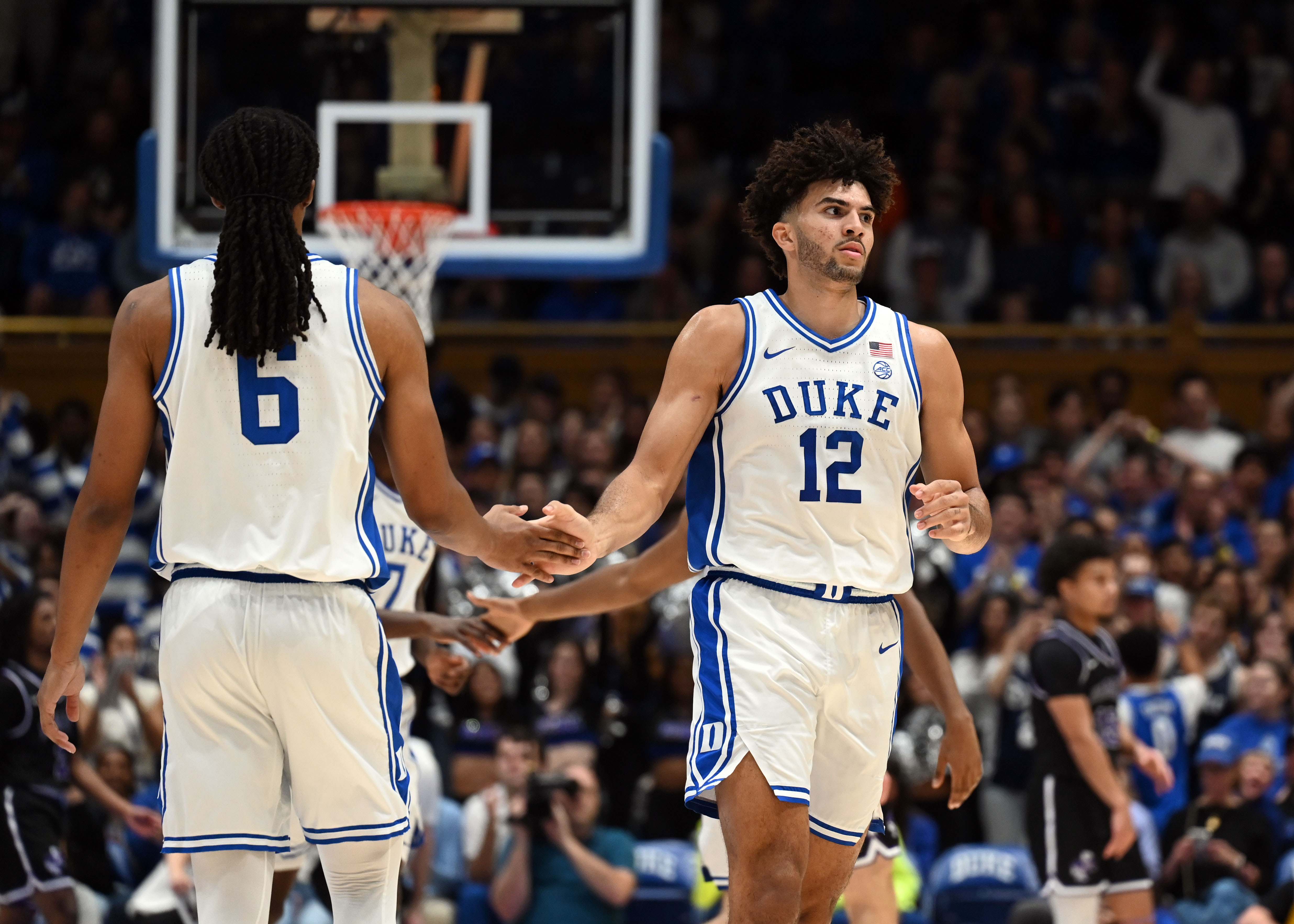 Duke forward Cameron Boozer (12) high-fives a teammate as we offer our Duke vs. Arkansas prediction