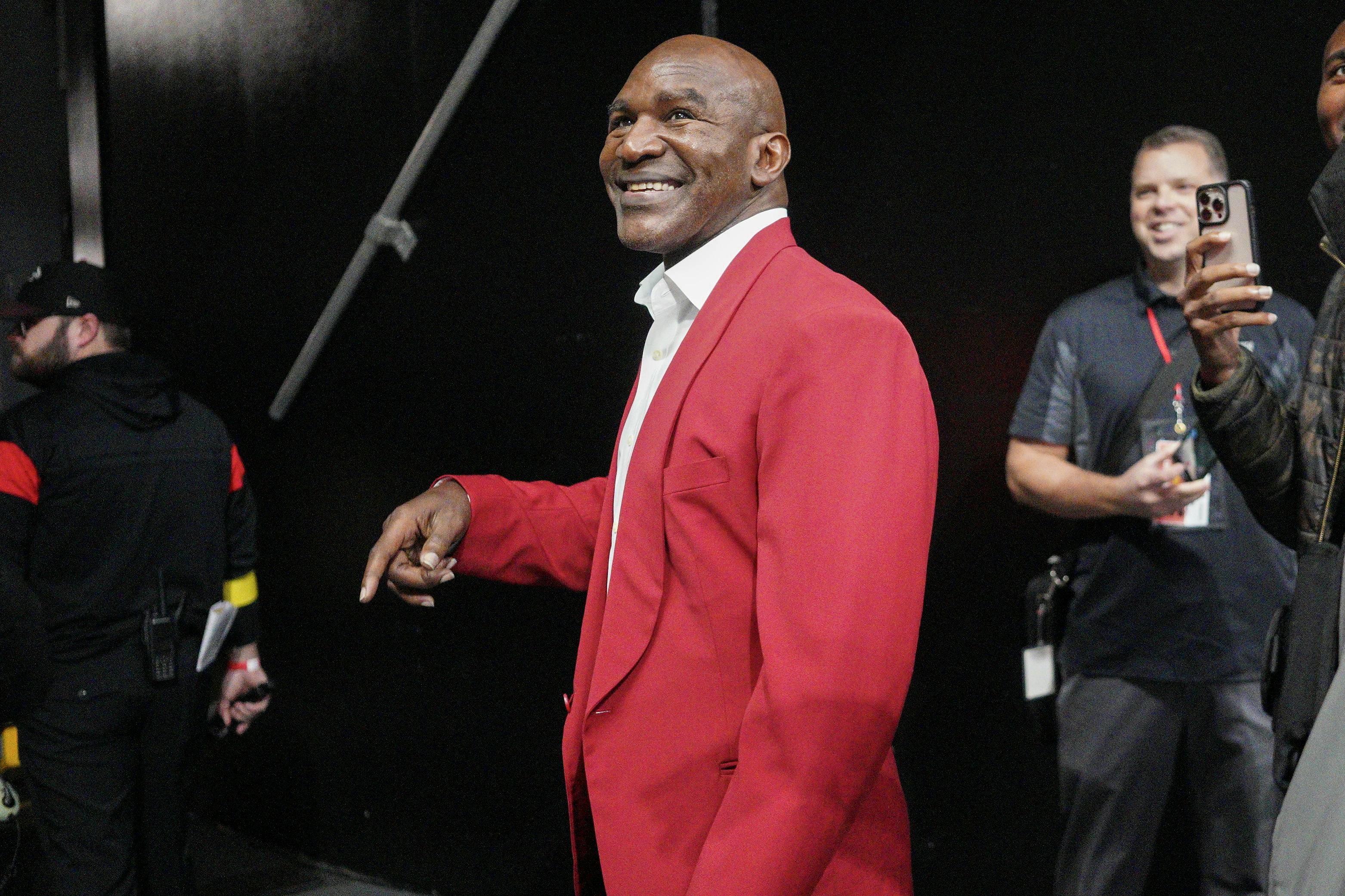 Former boxer Evander Holyfield on the field before a game between the Atlanta Falcons and Pittsburgh Steelers at Mercedes-Benz Stadium.<br>