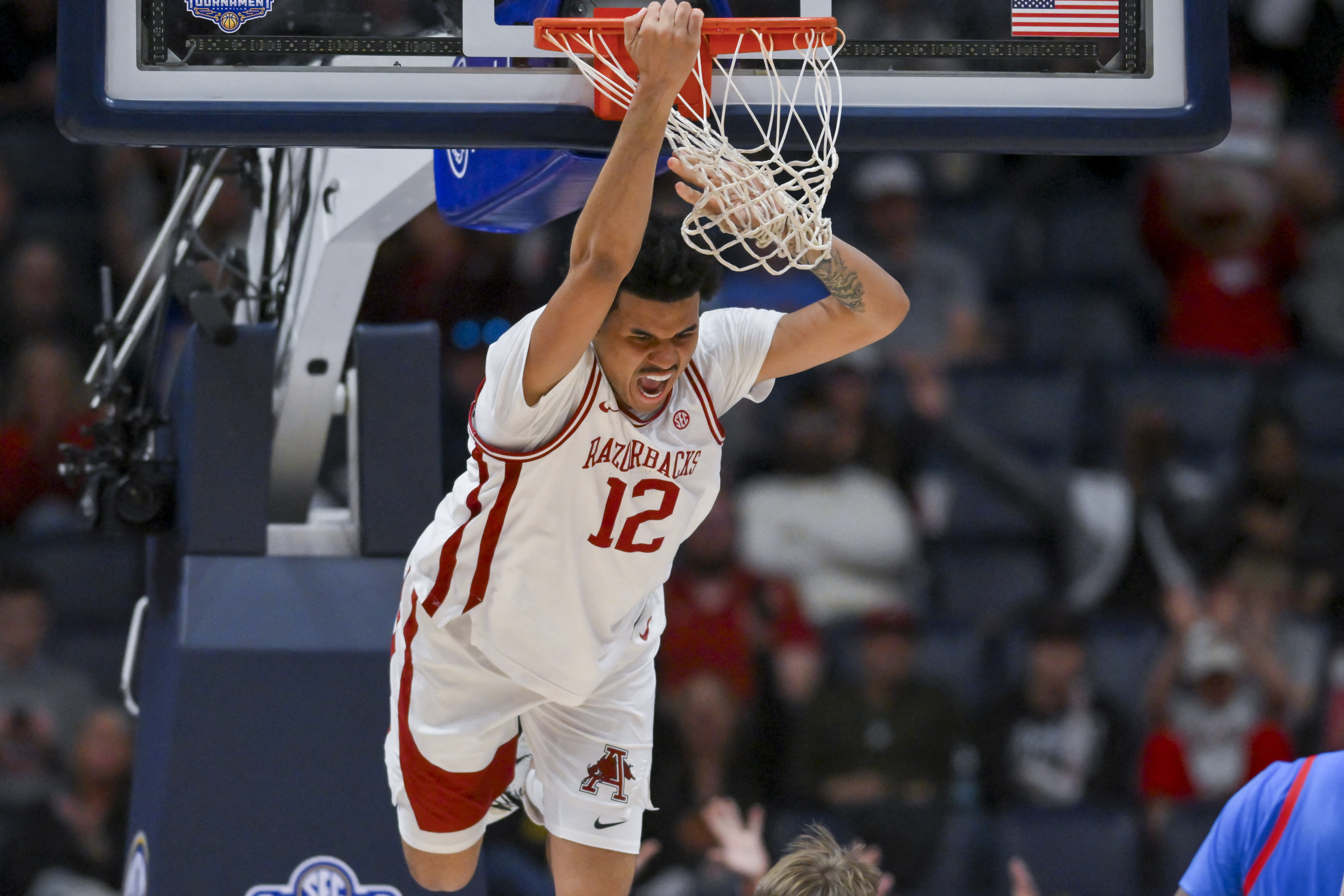 Arkansas Razorbacks forward Malique Ewin dunks the ball as we offer our best Vanderbilt vs. Arkansas SEC Championship prediction.