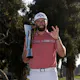 Jon Rahm celebrates with the trophy after winning The Genesis Invitational on Feb. 19. Rahm is now favored in the latest PGA championship odds.