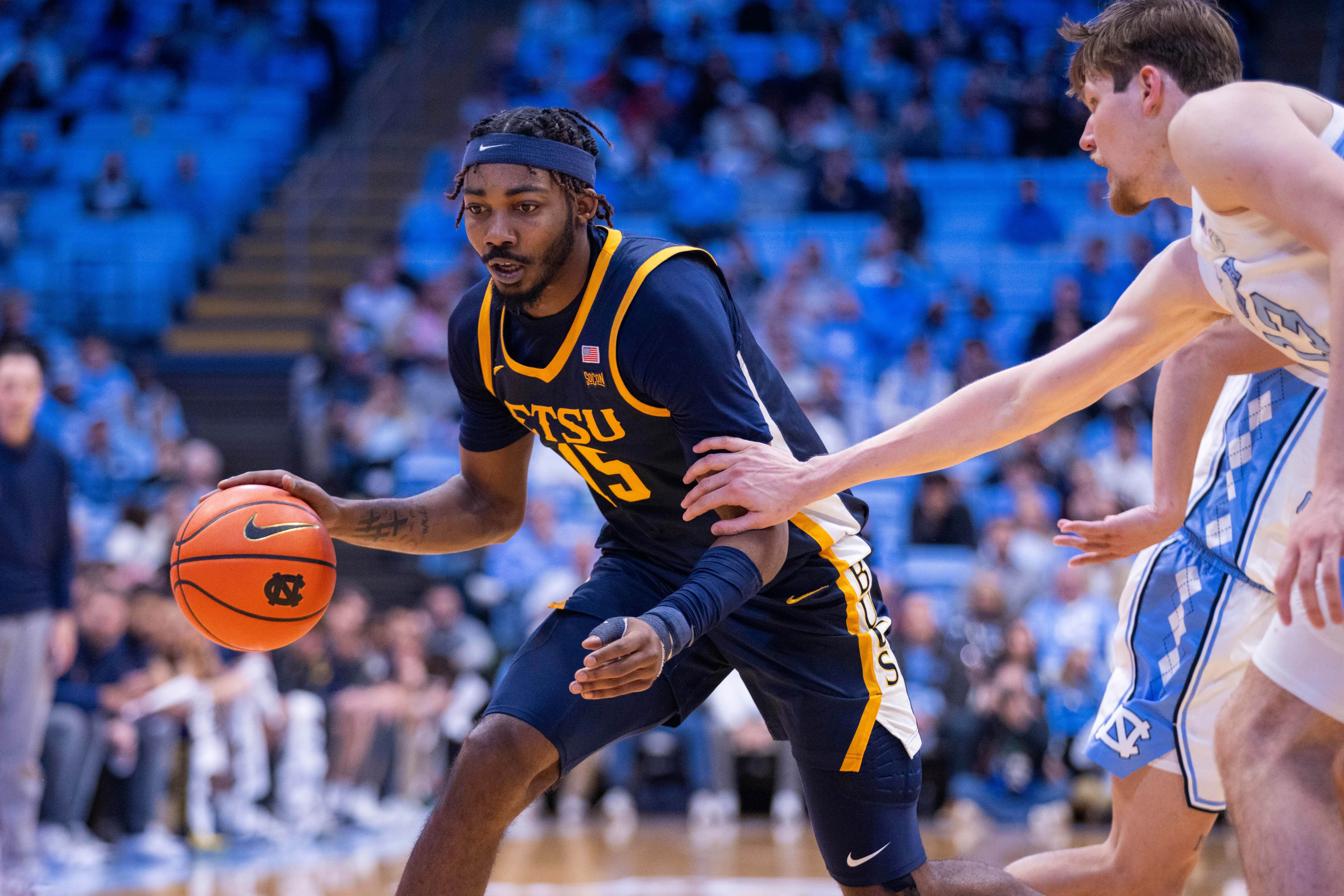 ETSU Buccaneers forward Cam Morris III drives with the ball as we make our college basketball best bets for Monday.