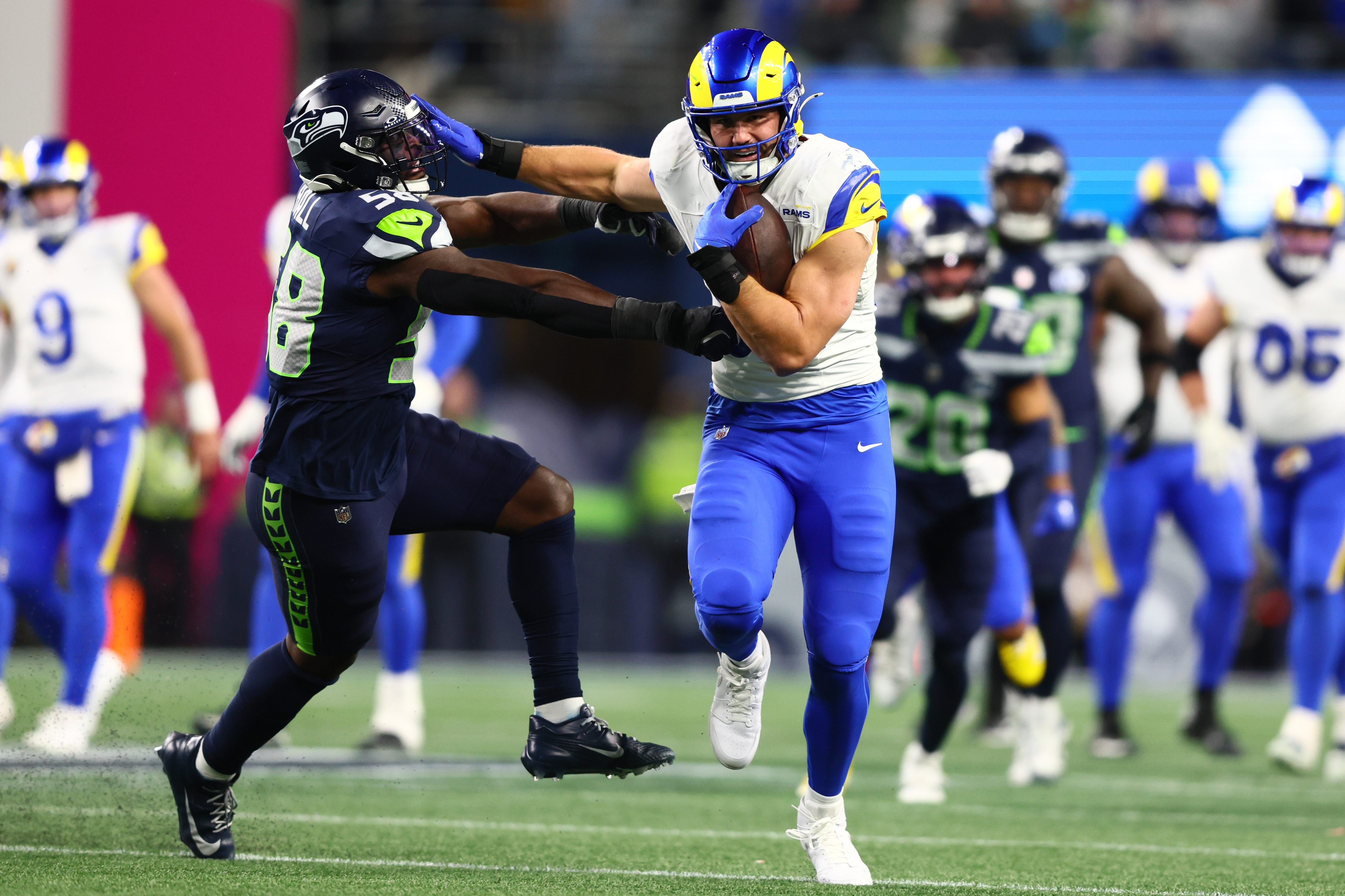 Los Angeles Rams tight end Colby Parkinson (84) runs against Seattle Seahawks linebacker Derick Hall (58) during the second half in the 2026 NFC Championship Game at Lumen Field.
