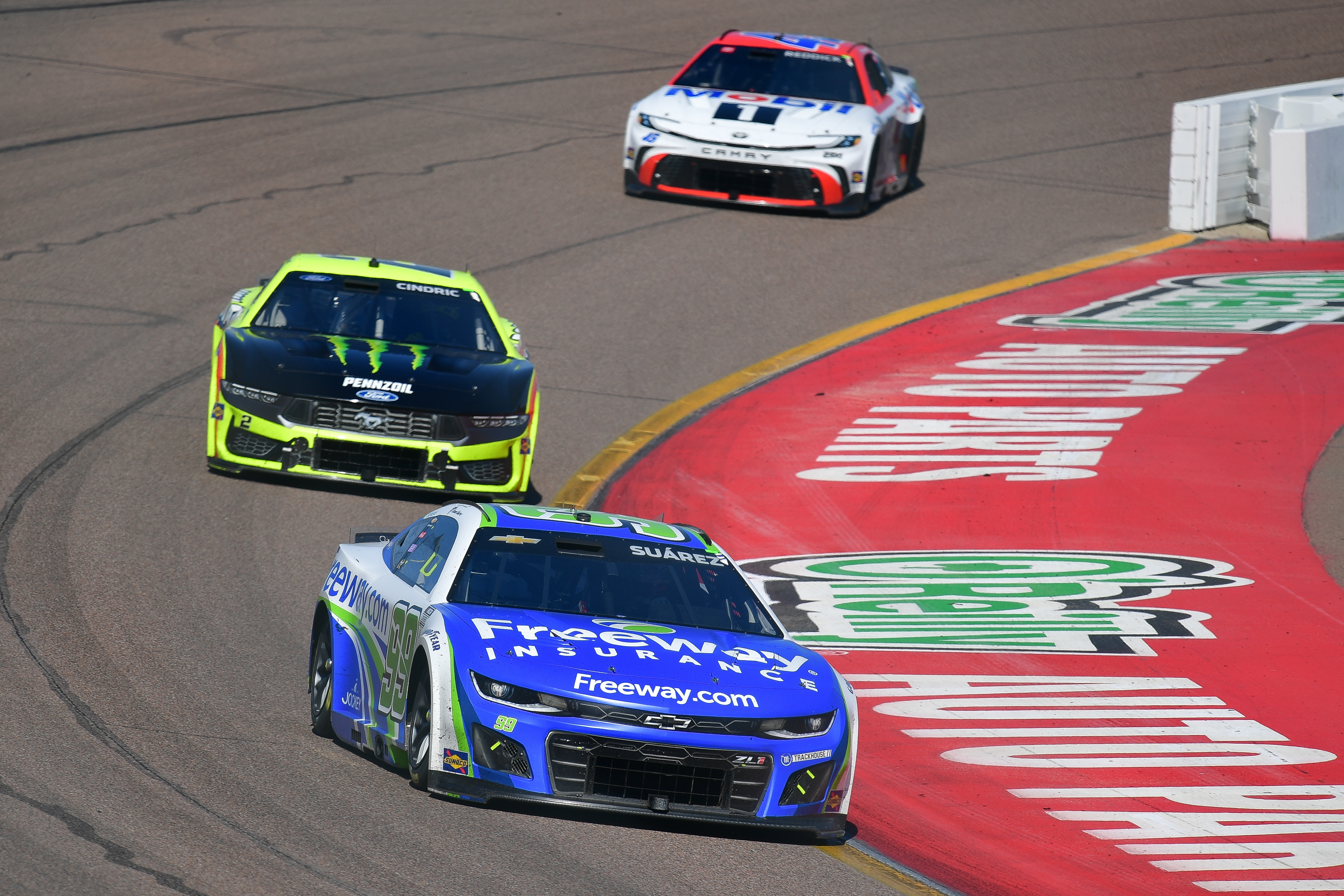NASCAR Cup Series driver Daniel Suarez (99) leads Ryan Blaney (12) and Tyler Reddick (45) at Phoenix Raceway.
