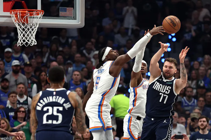 Luka Doncic (77) of the Dallas Mavericks attempts a pass past Luguentz Dort (5) and Shai Gilgeous-Alexander (2) of the Oklahoma City Thunder, as we offer our best Thunder vs. Mavericks player props and expert picks for Monday's Game 4 in Dallas.