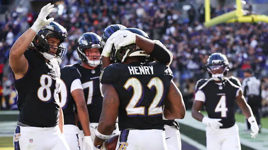 Baltimore Ravens running back Derrick Henry (22) celebrates with teammates as we offer our NFL predictions for Week 9.