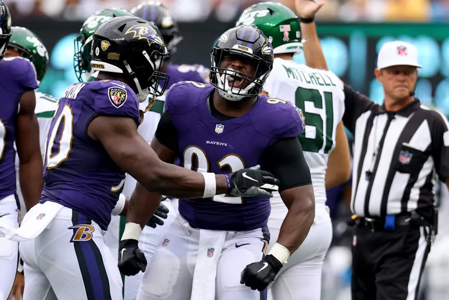 Justin Houston and Justin Madubuike of the Baltimore Ravens celebrate after a defensive play against the New York Jets.