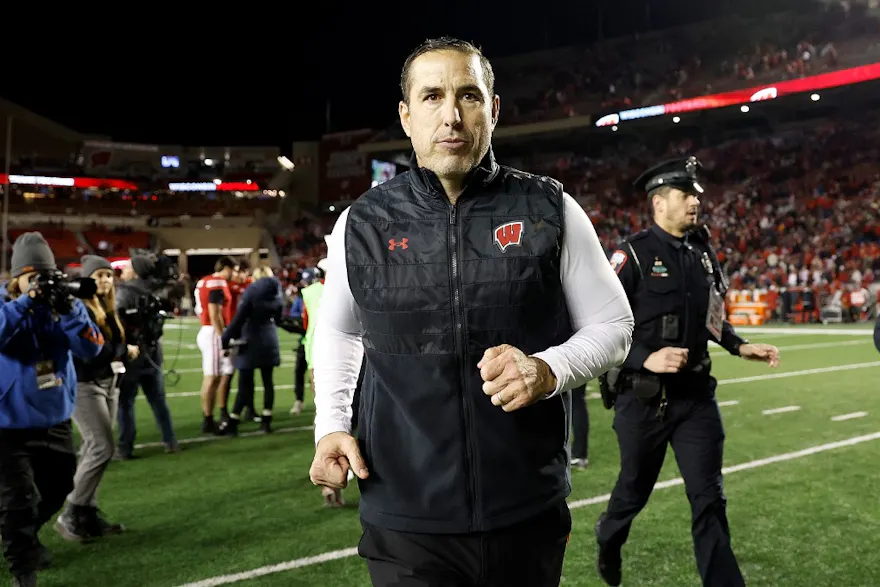Luke Fickell head coach of the Wisconsin Badgers runs off the field after an overtime win against the Nebraska Cornhuskers as we look at our Wisconsin-LSU prediction.