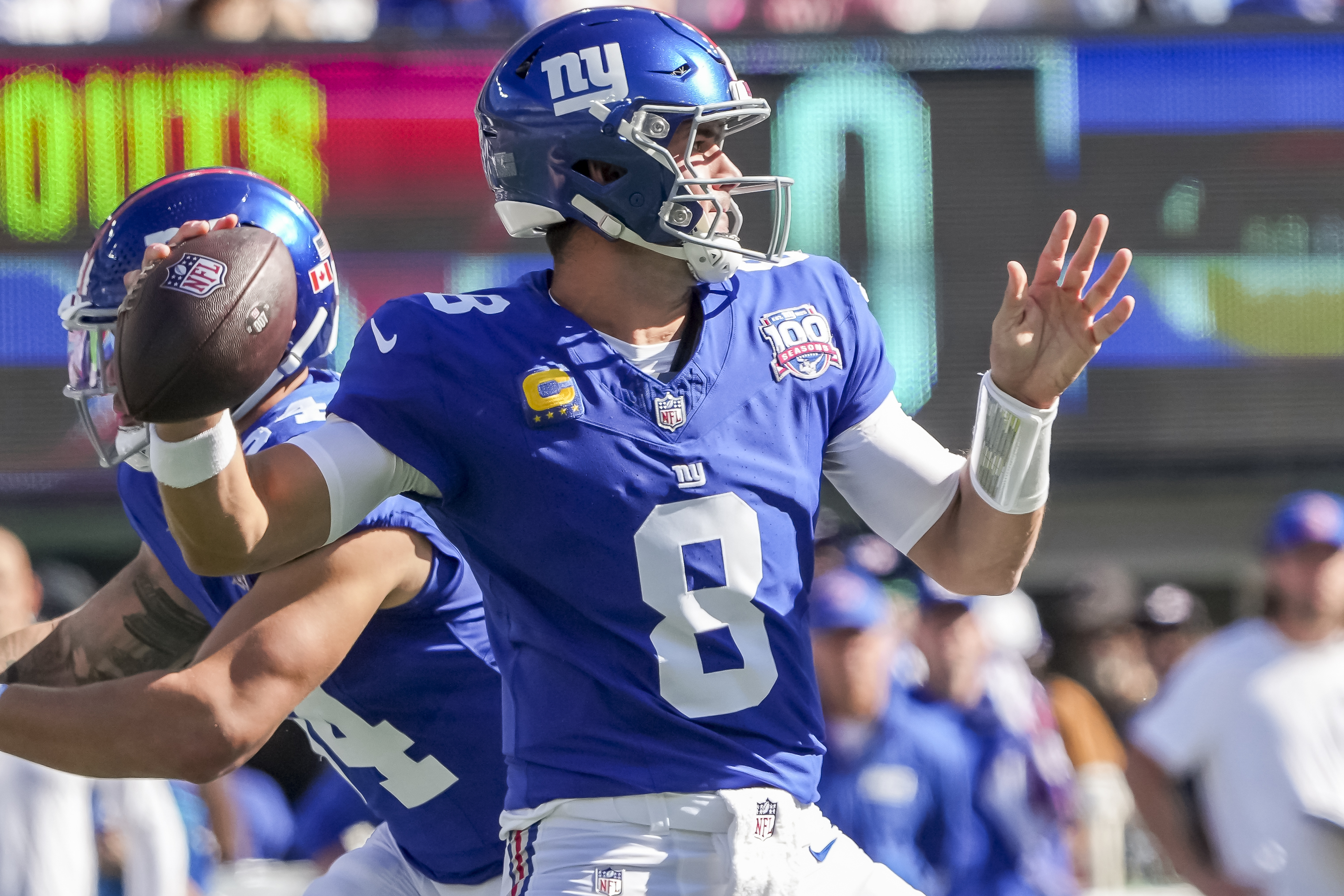 New York Giants quarterback Daniel Jones (8) winds up to pass as we offer our sports equinox best bets and parlay picks.