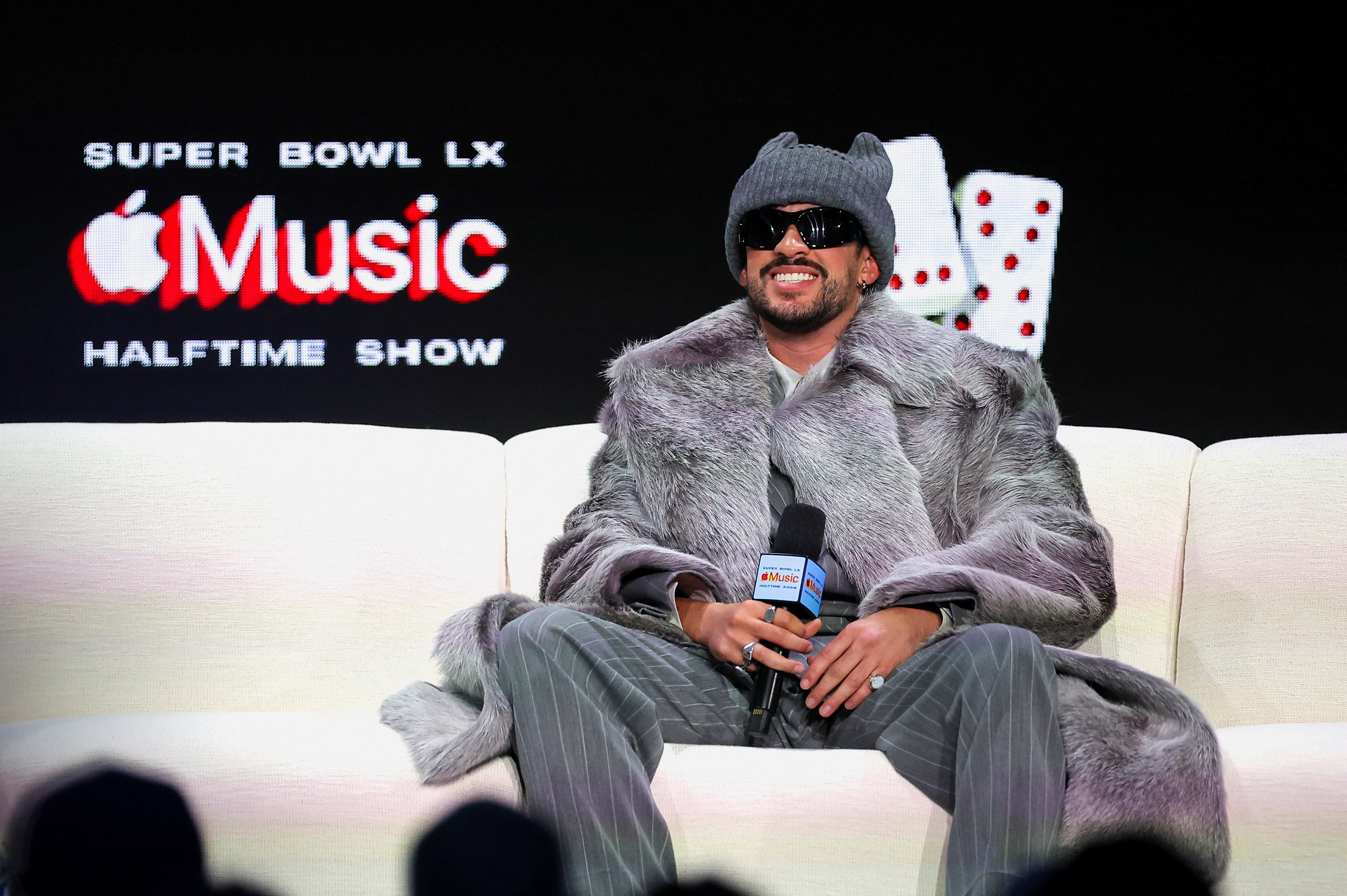 Grammy Award-winning global recording artist Bad Bunny smiles during his halftime show press conference.