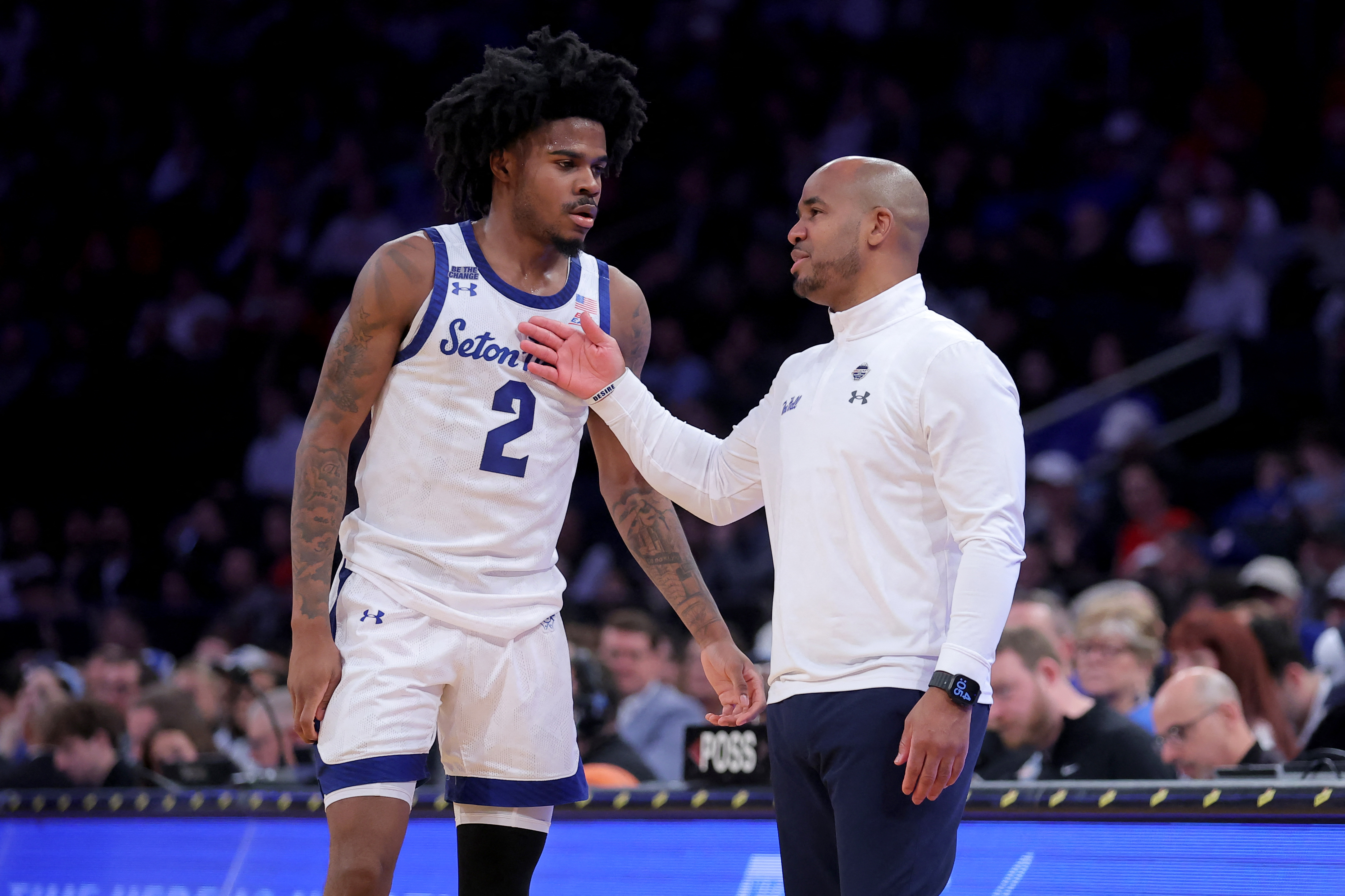 Seton Hall Pirates head coach Shaheen Holloway talks to guard Tajuan Simpkins as we make our best Seton Hall vs. St. John's prediction.