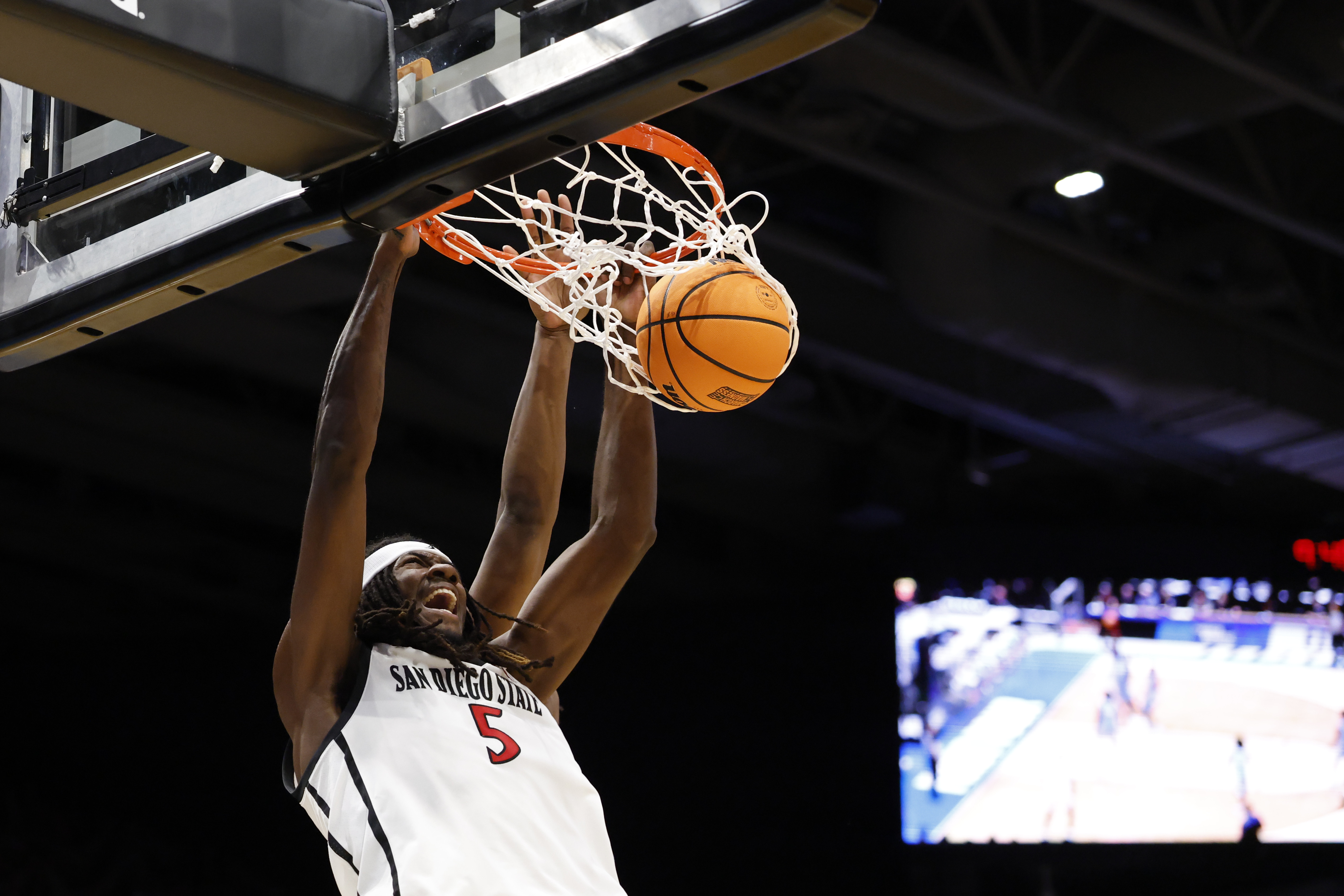 San Diego State Aztecs forward Pharaoh Compton (5) dunks the ball as we break down our  San Diego State vs. Utah State prediction.