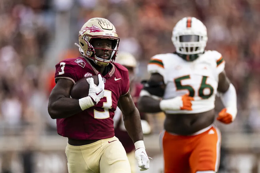Trey Benson #3 of the Florida State Seminoles runs the ball as we look at our college football player props for Week 14