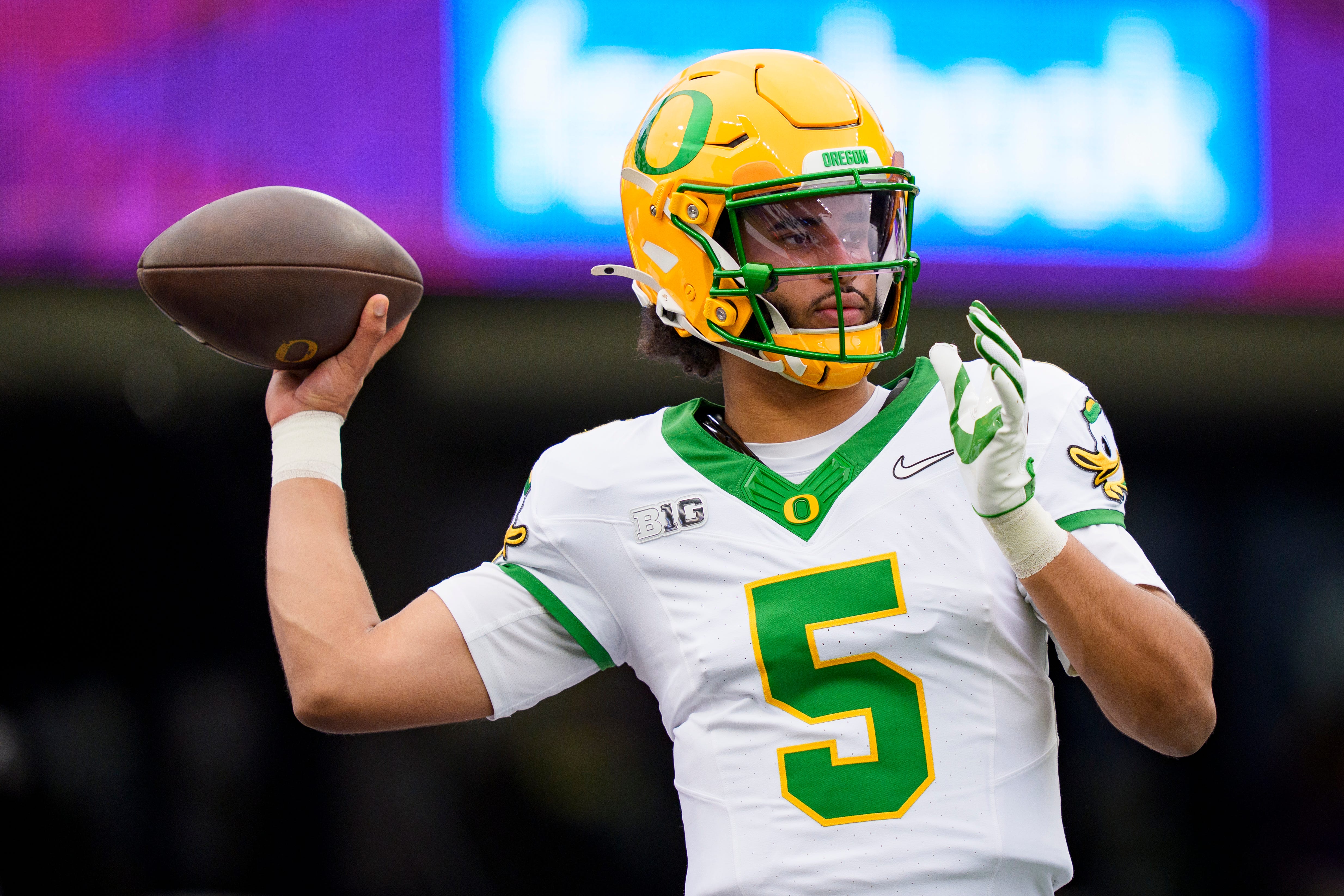 Oregon quarterback Dante Moore warms up as we offer our James Madison vs. Oregon prediction