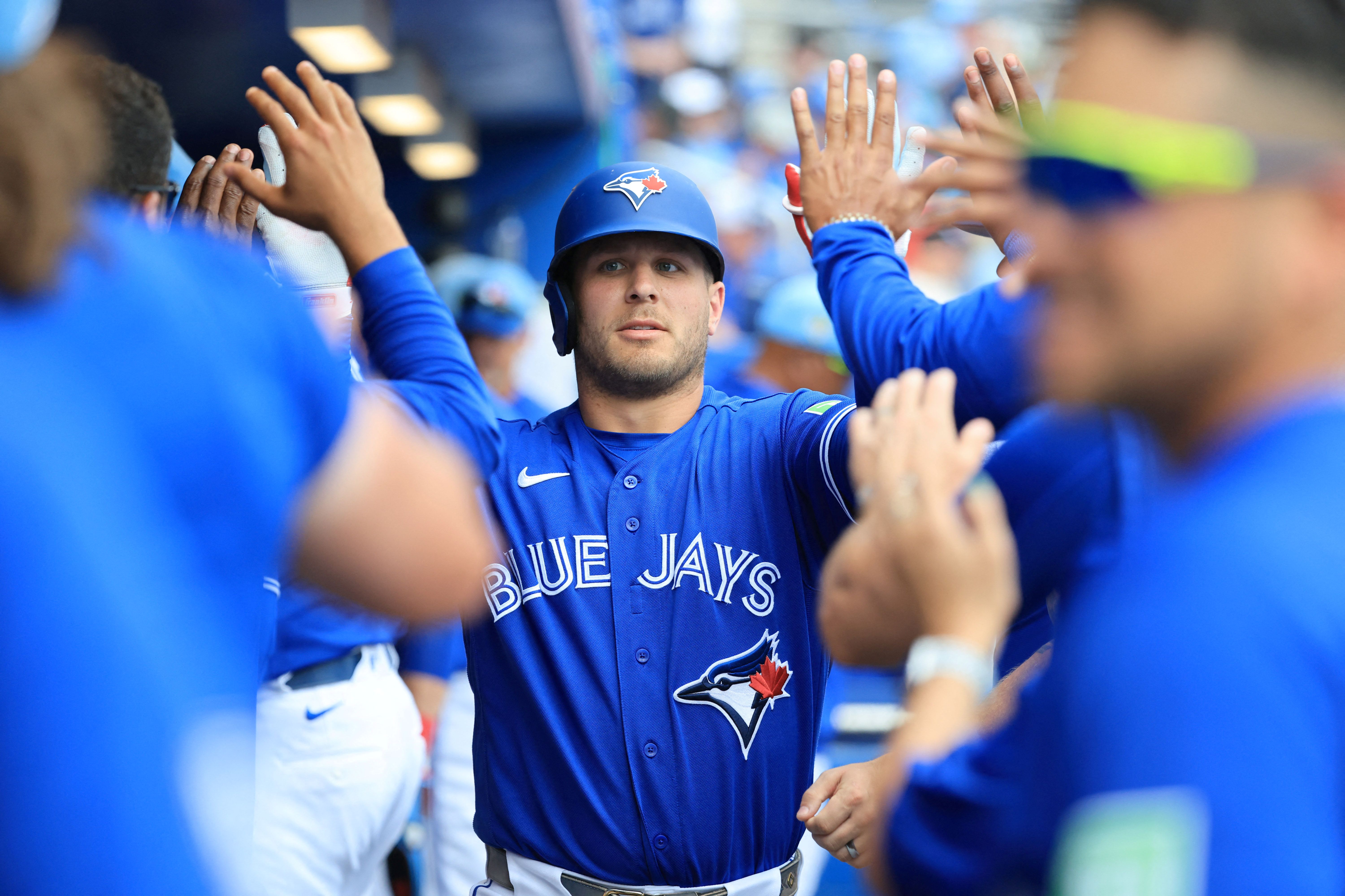 Toronto Blue Jays center fielder Daulton Varsho is congratulated after hitting a home run, and he's key to our Athletics vs. Blue Jays prediction.