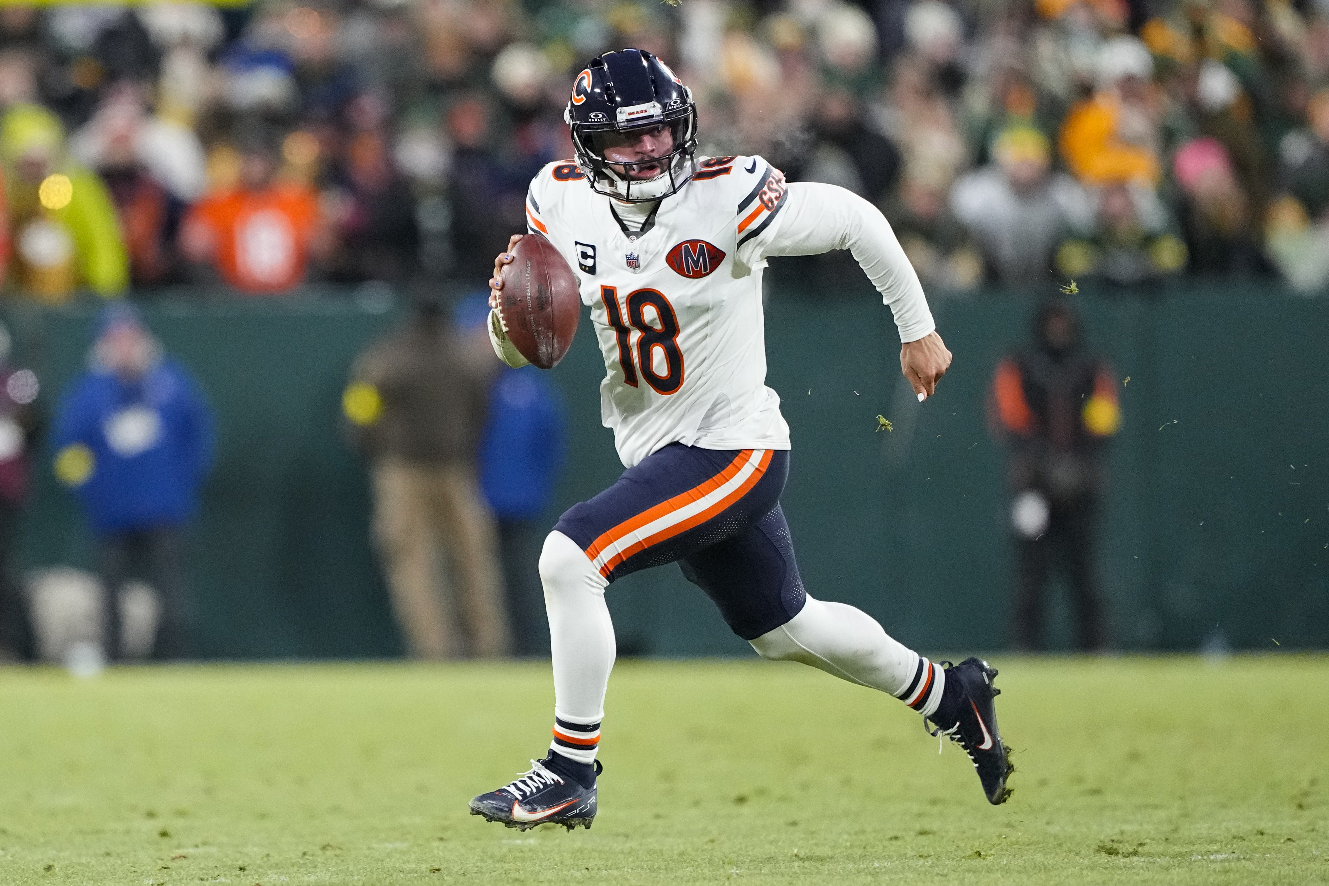 Chicago Bears quarterback Caleb Williams (18) runs as we offer our Bears vs. 49ers player props for Sunday Night Football.