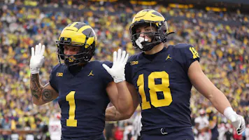 Roman Wilson of the Michigan Wolverines celebrates his first-half touchdown with Colston Loveland while we look at the latest Big Ten title odds.