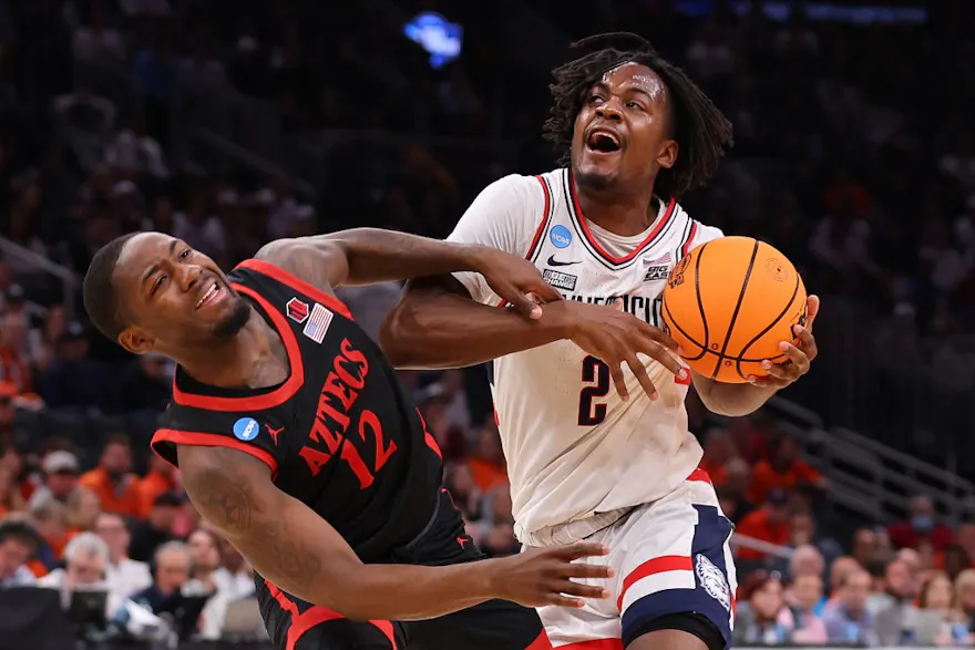 Tristen Newton #2 of the Connecticut Huskies drives to the basket as we make our men's national championship expert picks