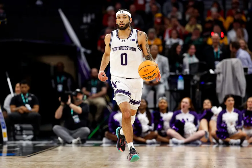 Boo Buie of the Northwestern Wildcats dribbles the ball against the Wisconsin Badgers in the first half at Target Center in the Quarterfinals of the Big Ten Tournament as we look at our Northwestern-UConn prediction.
