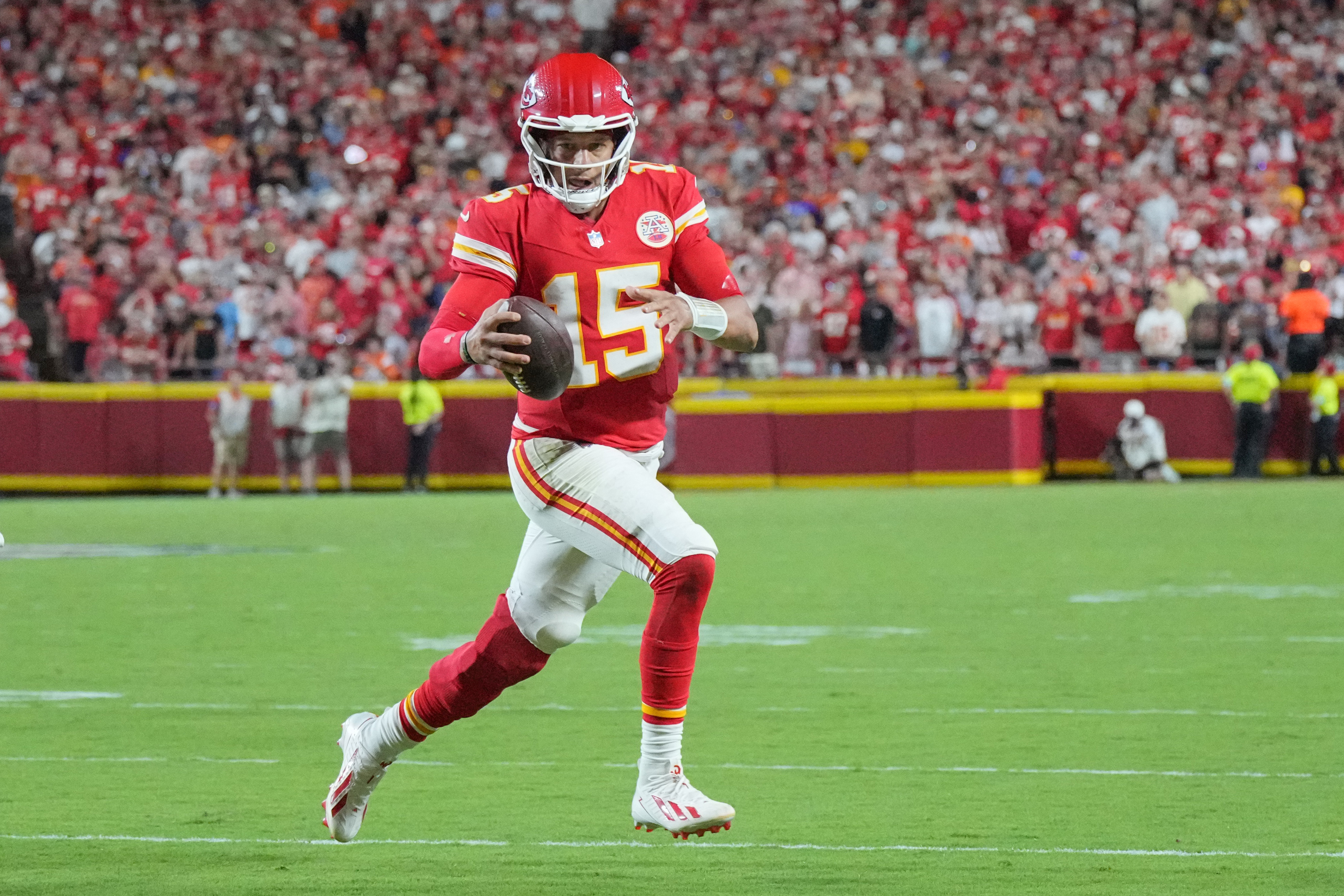 Kansas City Chiefs quarterback Patrick Mahomes (15) scrambles as he is featured in our Chiefs vs. Dolphins prediction.