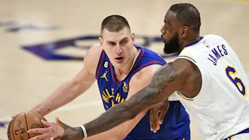 Nikola Jokic #15 of the Denver Nuggets handles the ball against LeBron James #6 of the Los Angeles Lakers as we offer our 2024 NBA playoffs Round 1 odds and predictions.