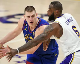 Nikola Jokic #15 of the Denver Nuggets handles the ball against LeBron James #6 of the Los Angeles Lakers as we offer our 2024 NBA playoffs Round 1 odds and predictions.