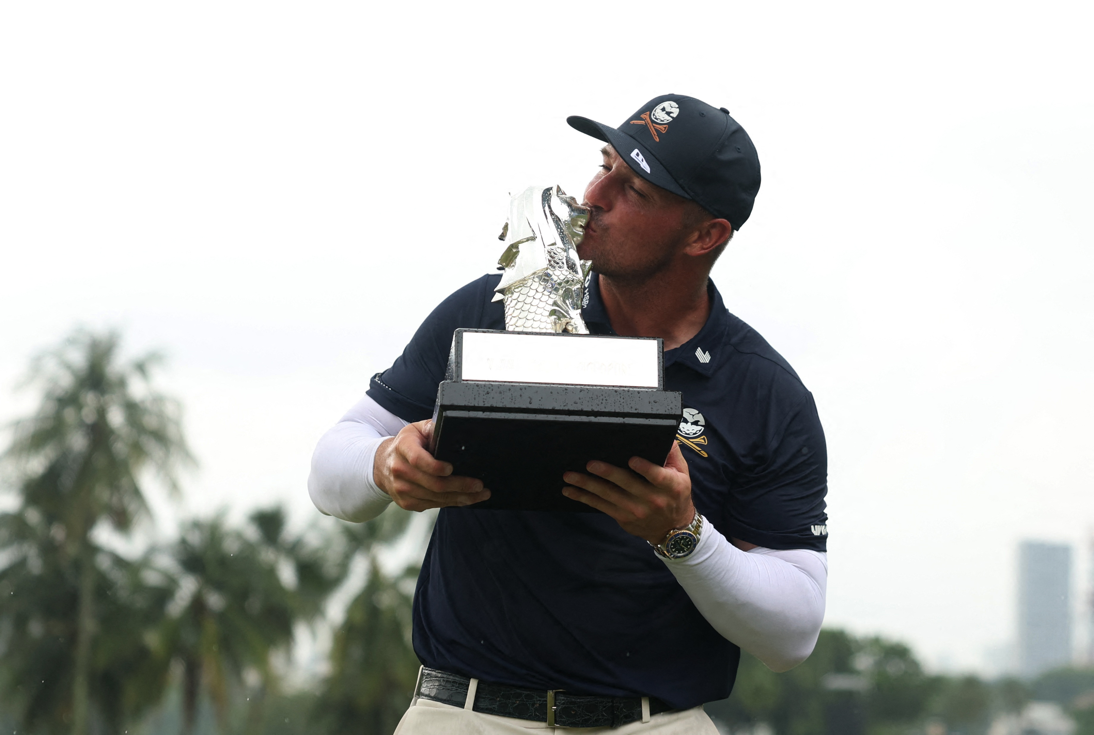 Bryson DeChambeau celebrates with his trophy after winning the LIV Golf Singapore