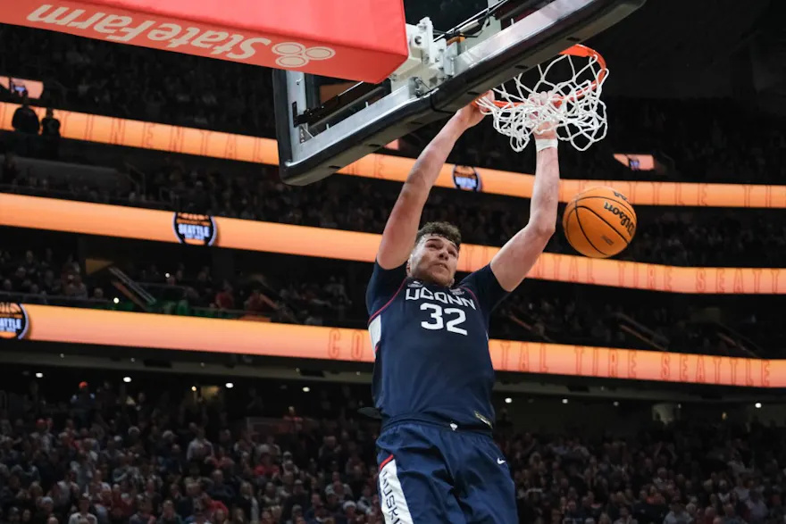 Donovan Clingan #32 of the Connecticut Huskies dunks an alley-oop as we look at Connecticut's legal sports betting financials for November 2023.