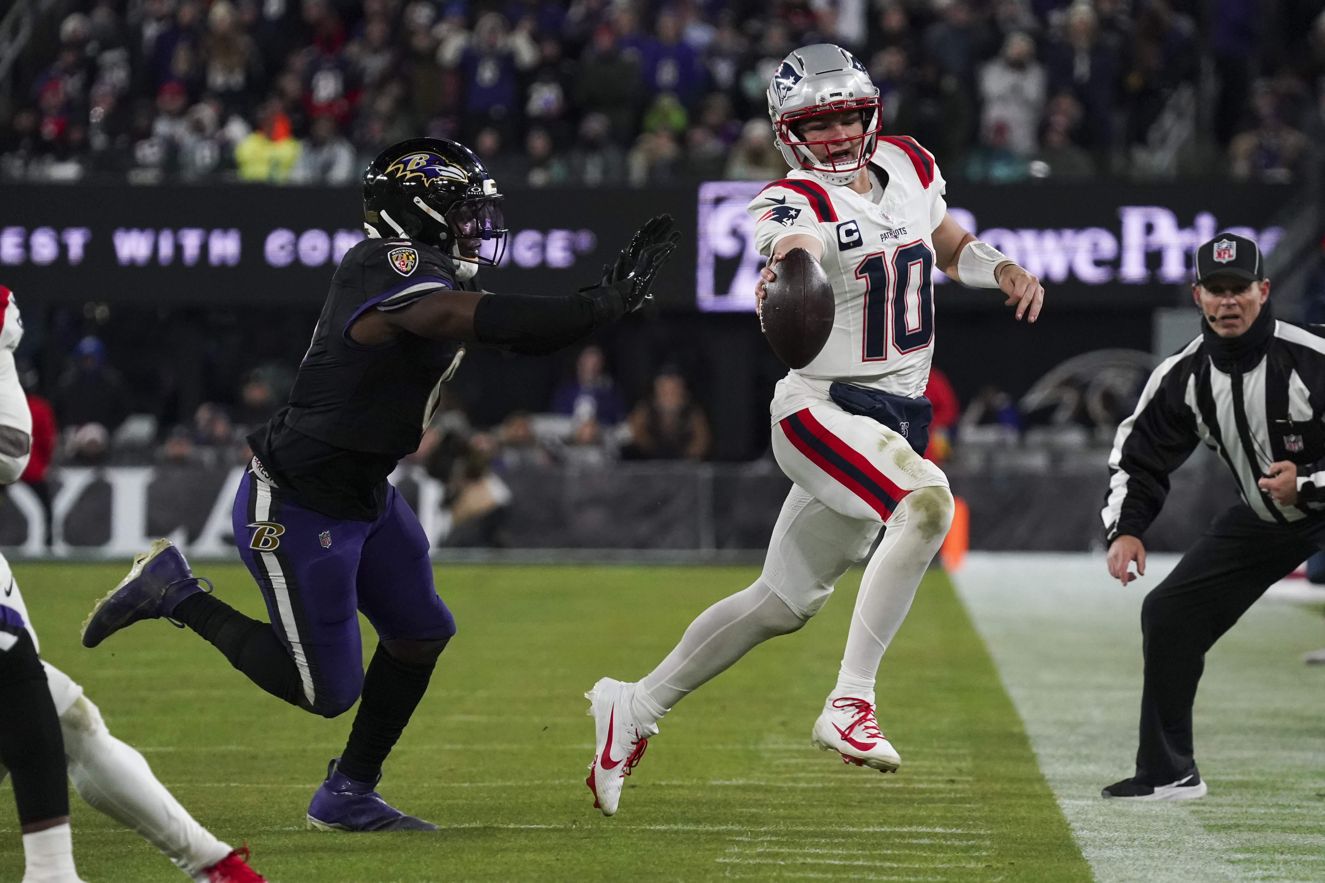 Baltimore Ravens linebacker Roquan Smith (0) pushes New England Patriots quarterback Drake Maye (10) out of bounds as we break down the NFL MVP odds after Week 16.