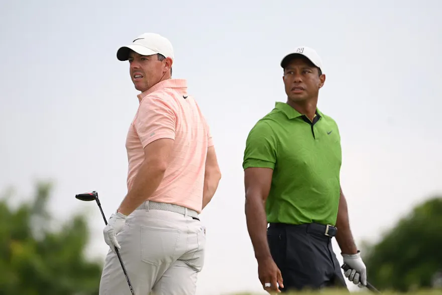 Rory McIlroy of Northern Ireland and Tiger Woods of the United States watch a tee shot on the 10th tee during the second round of the 2022 PGA Championship at Southern Hills Country Club on May 20, 2022 in Tulsa, Oklahoma.