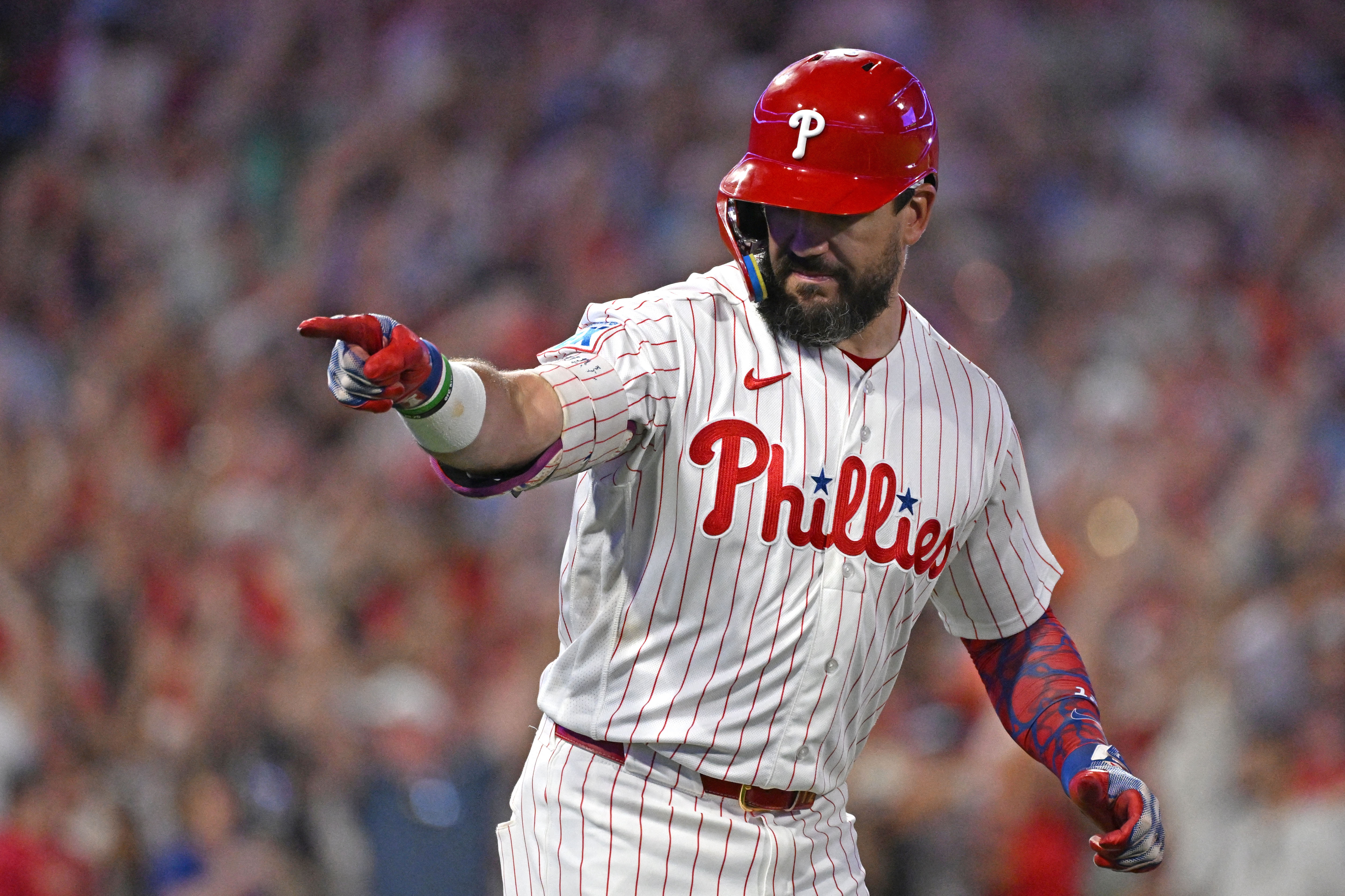 Philadelphia Phillies designated hitter Kyle Schwarber (12) points up to the dugout as he is featured in our Phillies vs. Braves prediction.