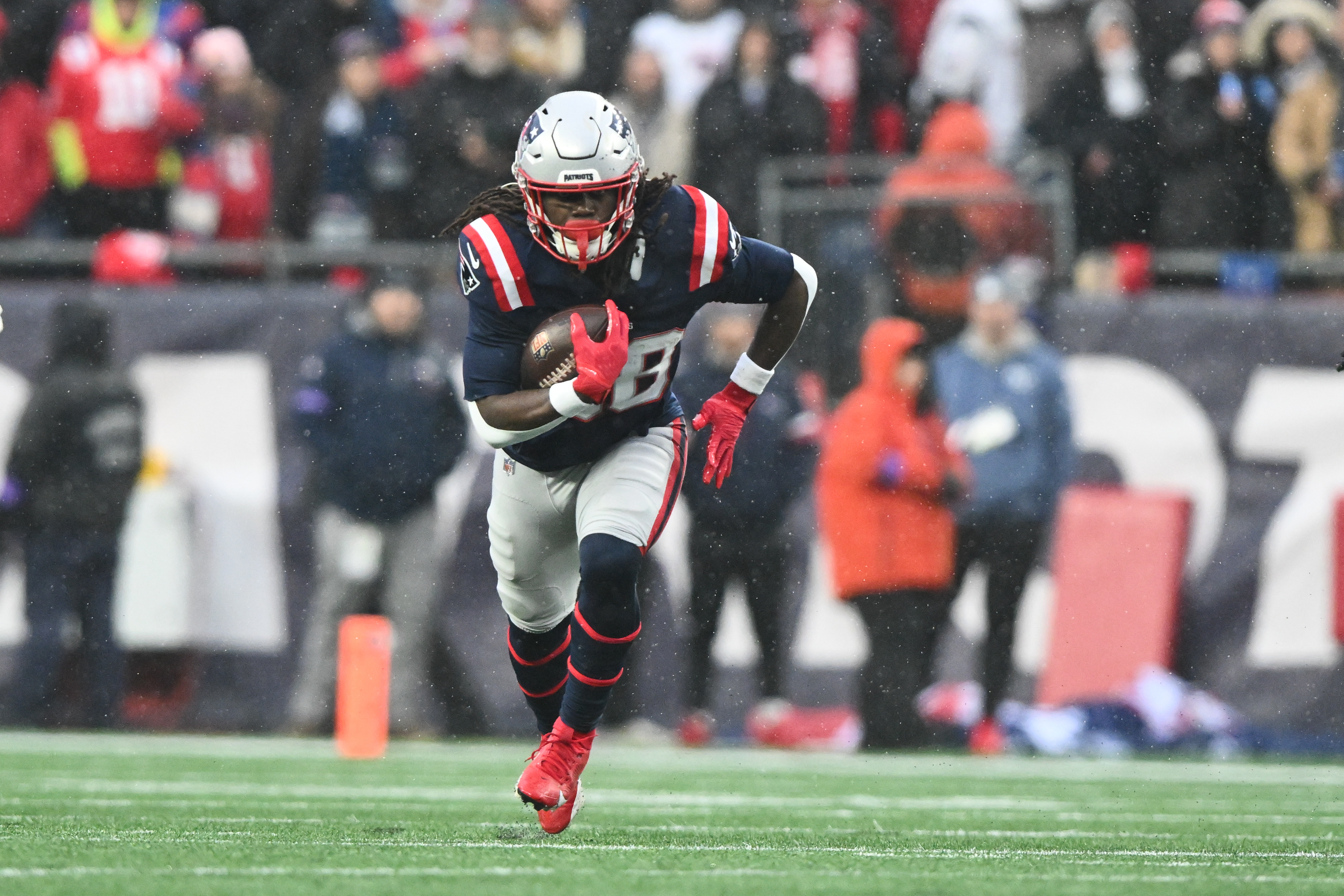New England Patriots running back Rhamondre Stevenson (38) runs with the ball as we provide our best Super Bowl running back player props.