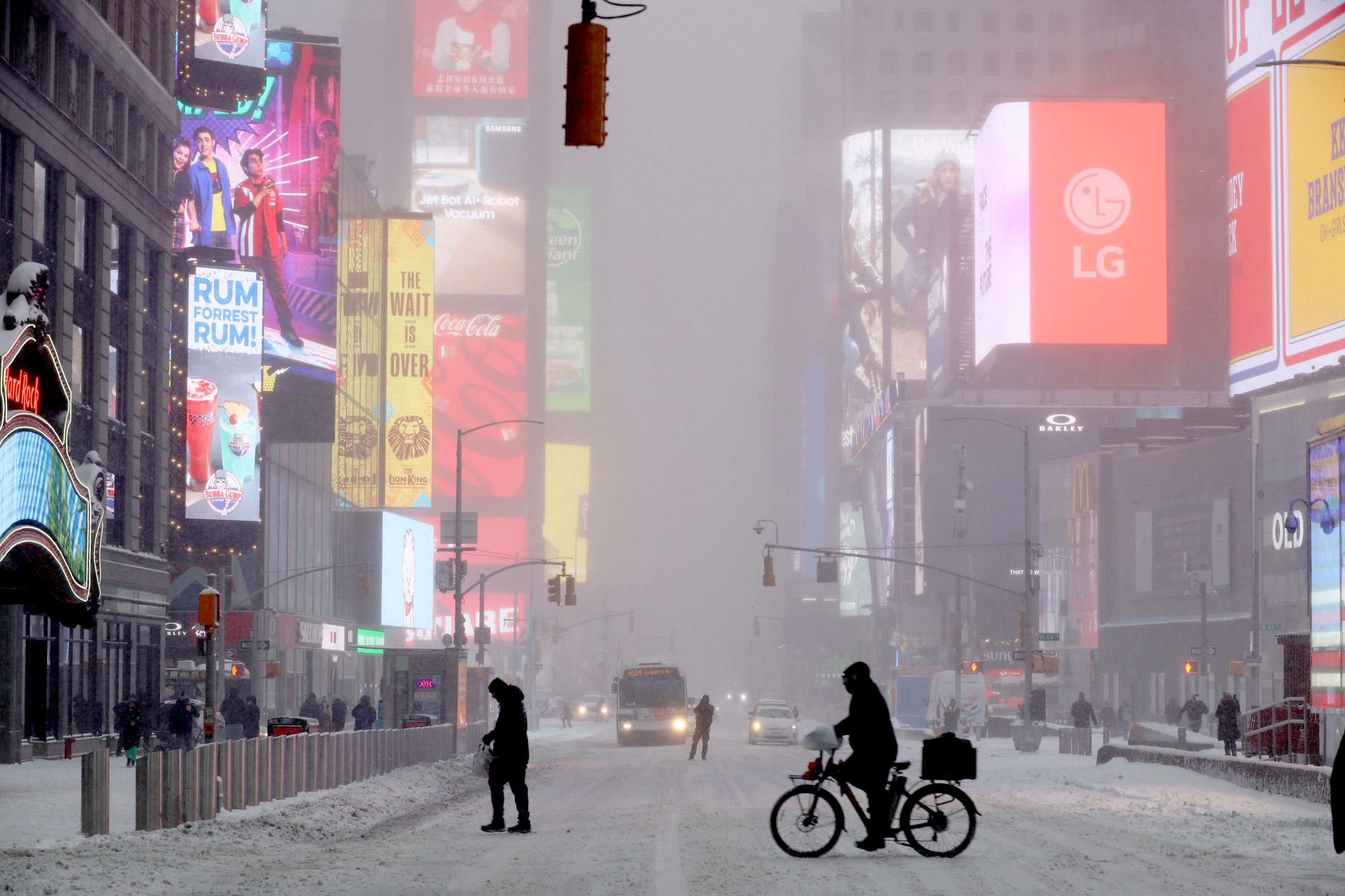 A bicycle delivery worker makes his way through a snow-covered Times Square in New York City as we look at the White Christmas in New York City prediction market