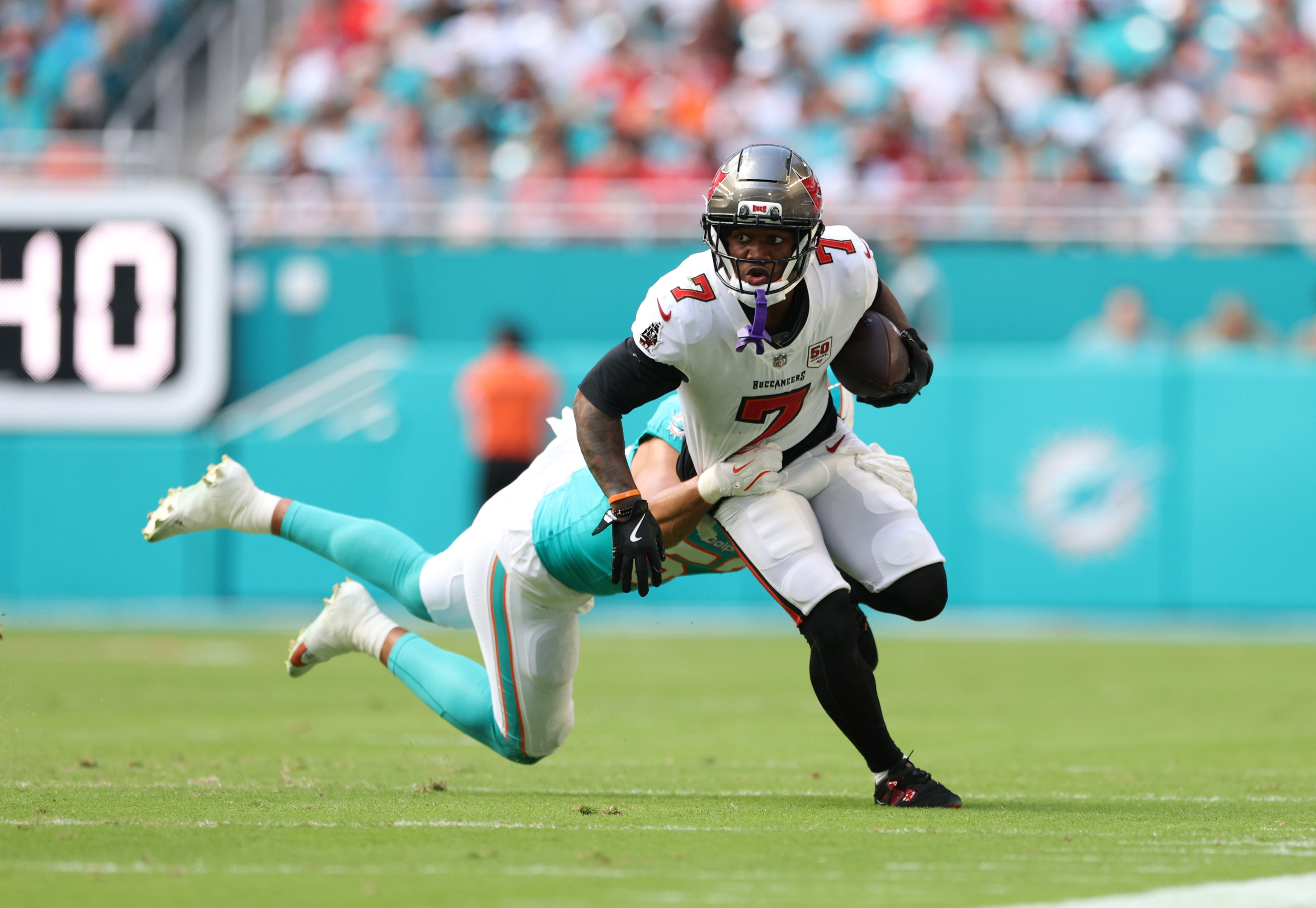 Tampa Bay Buccaneers running back Bucky Irving (7) is tackled as we break down our Panthers vs. Buccaneers player props