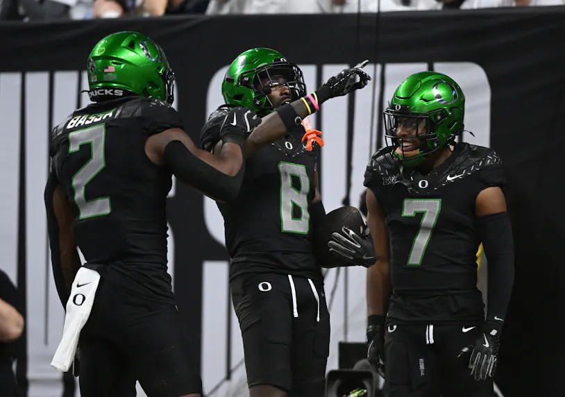 Oregon Ducks quarterback Dillon Gabriel (8), wide receiver Gary Bryant Jr. (2) and wide receiver Evan Stewart (7) celebrate as we make our Ohio State vs. Oregon prediction ahead of tonight's CFP Rose Bowl.