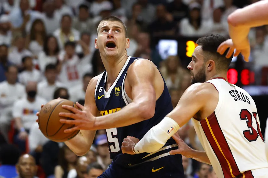 Nikola Jokic of the Denver Nuggets drives to the basket against Max Strus of the Miami Heat during the first quarter in Game Four of the 2023 NBA Finals at Kaseya Center as we look at our Heat-Nuggets pick.