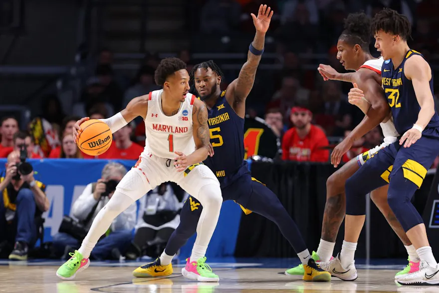 Jahmir Young of the Maryland Terrapins dribbles the ball against Joe Toussaint of the West Virginia Mountaineers during the NCAA Men's Basketball Tournament at Legacy Arena on Mar. 16, 2023 in Birmingham, Alabama.